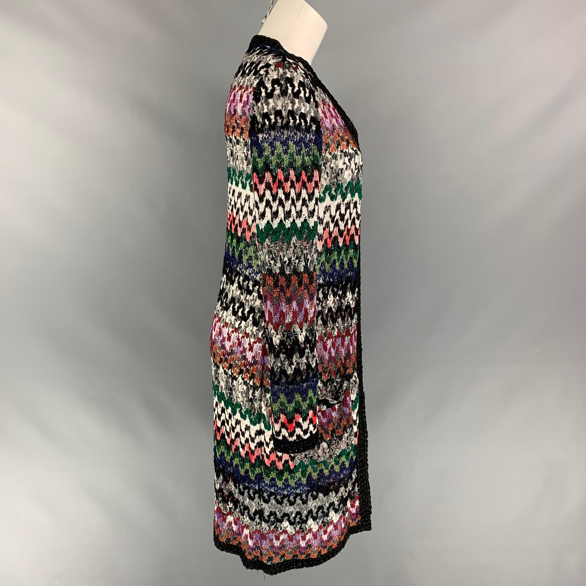 MISSONI cardigan comes in a multi-color knitted viscose blend featuring long sleeves and a open front. Made in Italy.

Very Good Pre-Owned Condition.
Marked: 38
Original Retail Price: $1,680.00

Measurements:

Shoulder: 13 in.
Bust: 36 in.
Sleeve:
