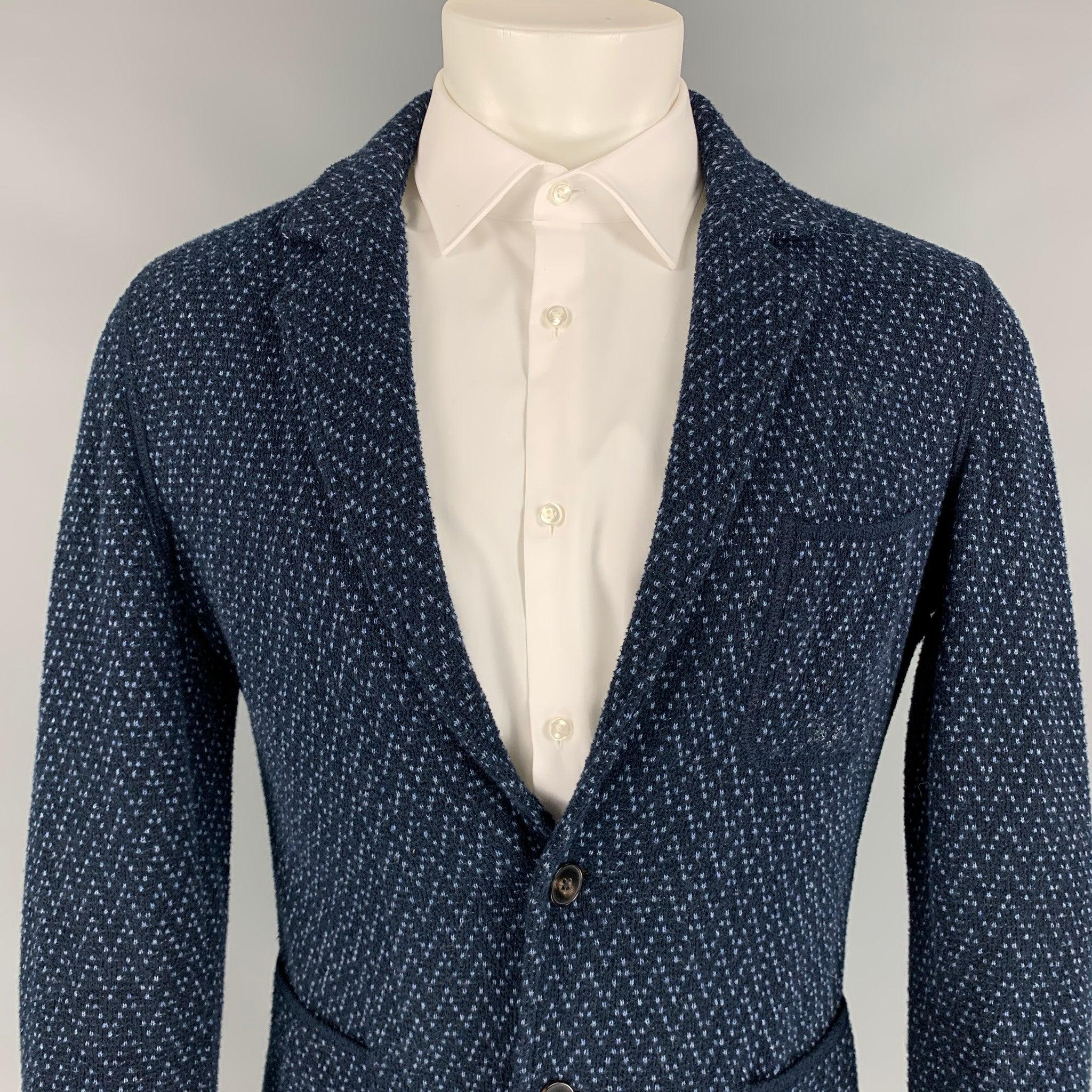 MISSONI sport coat comes in a black & blue textured material featuring a notch lapel, patch pockets, and a two button closure. Made in Italy.
Very Good
Pre-Owned Condition. 

Marked:   48 

Measurements: 
 
Shoulder: 18 inches  Chest: 38 inches 