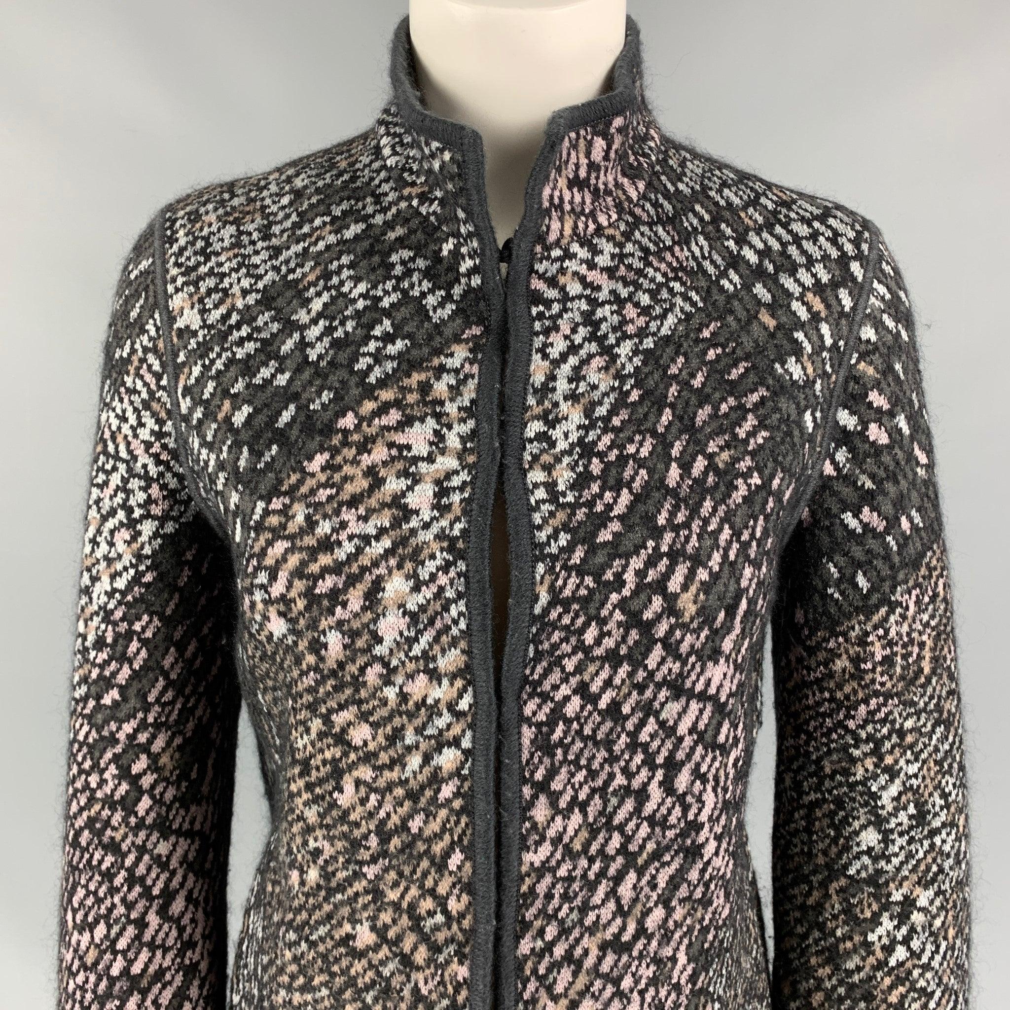 MISSONI jacket comes in a charcoal & silver knitted wool featuring a high collar, long sleeves, slit pockets, and a hook & loop closure. Made in Italy.
Very Good
Pre-Owned Condition. 

Marked:   40 

Measurements: 
 
Shoulder: 16 inches  Bust: 34