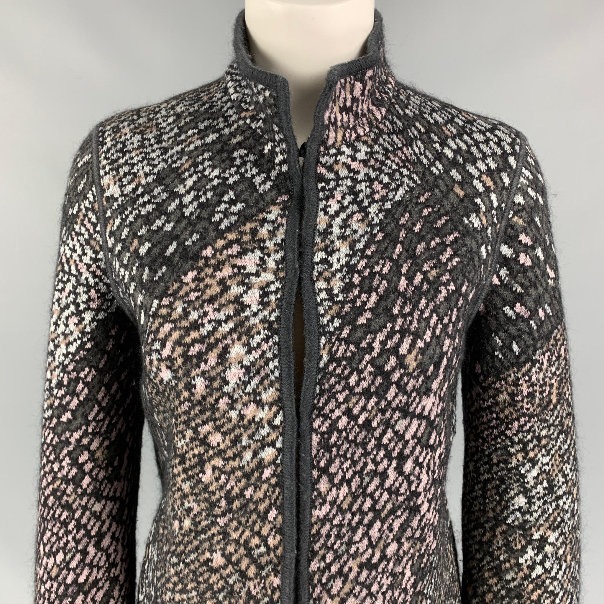 MISSONI jacket comes in a charcoal & silver knitted wool featuring a high collar, long sleeves, slit pockets, and a hook & loop closure. Made in Italy. 

Very Good Pre-Owned Condition.
Marked: 40

Measurements:

Shoulder: 16 in.
Bust: 34 in.
Sleeve: