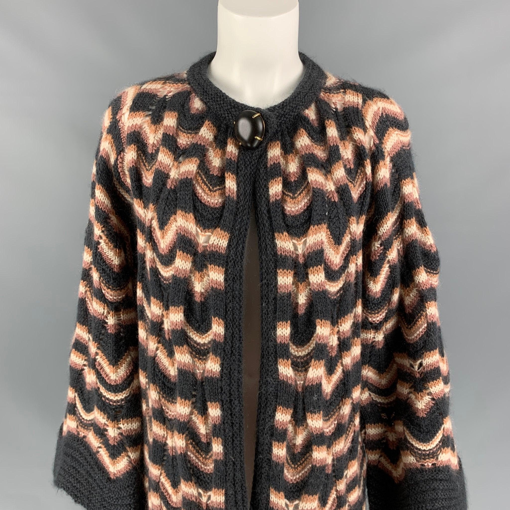 MISSONI coat comes in a dark gray & rose knitted wool / mohair featuring wide arm, large button detail, and a open front. Made in Italy.
Very Good
Pre-Owned Condition. 

Marked:  42 

Measurements: 
 
Shoulder: 16.5 inches Bust: 38 inches Sleeve: 27