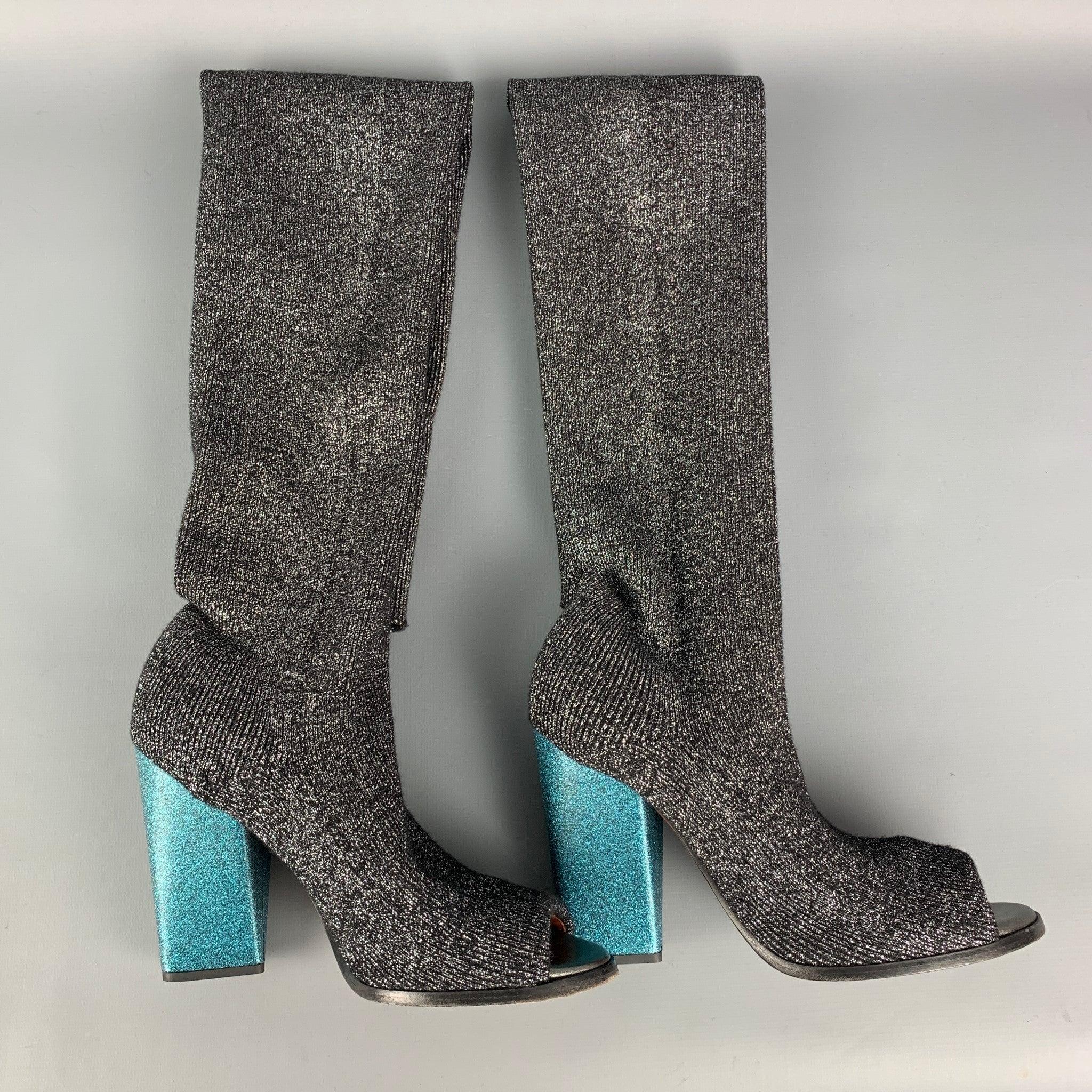 MISSONI thigh high boots comes in black & silver metallic lurex featuring a pull on style, open toe, and a chunky heel. Made in Italy.
New With Box.
 

Marked:   37 

Measurements: 
  Length: 8 inches  Width: 3.5 inches  Height: 25 inches 
  
  
