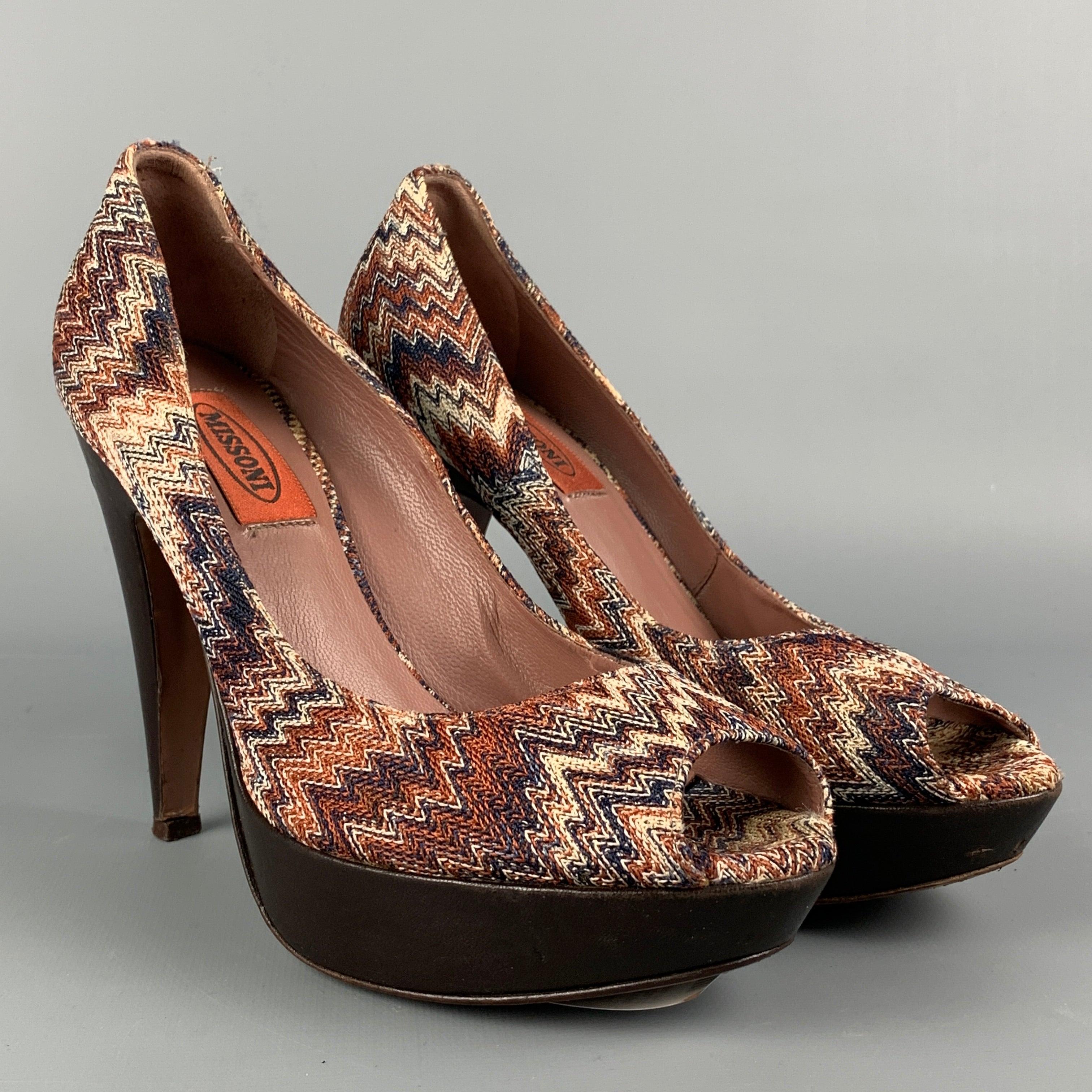 MISSONI pumps comes in a multi-color zig zag material featuring a peep toe, platform, and a covered heel. Made in Italy.
 Good
 Pre-Owned Condition. Minor wear.  
 

 Marked:  38 
 

 Measurements: 
  Heel: 4.5 inches Platform: 1 inches 
  
  
  
