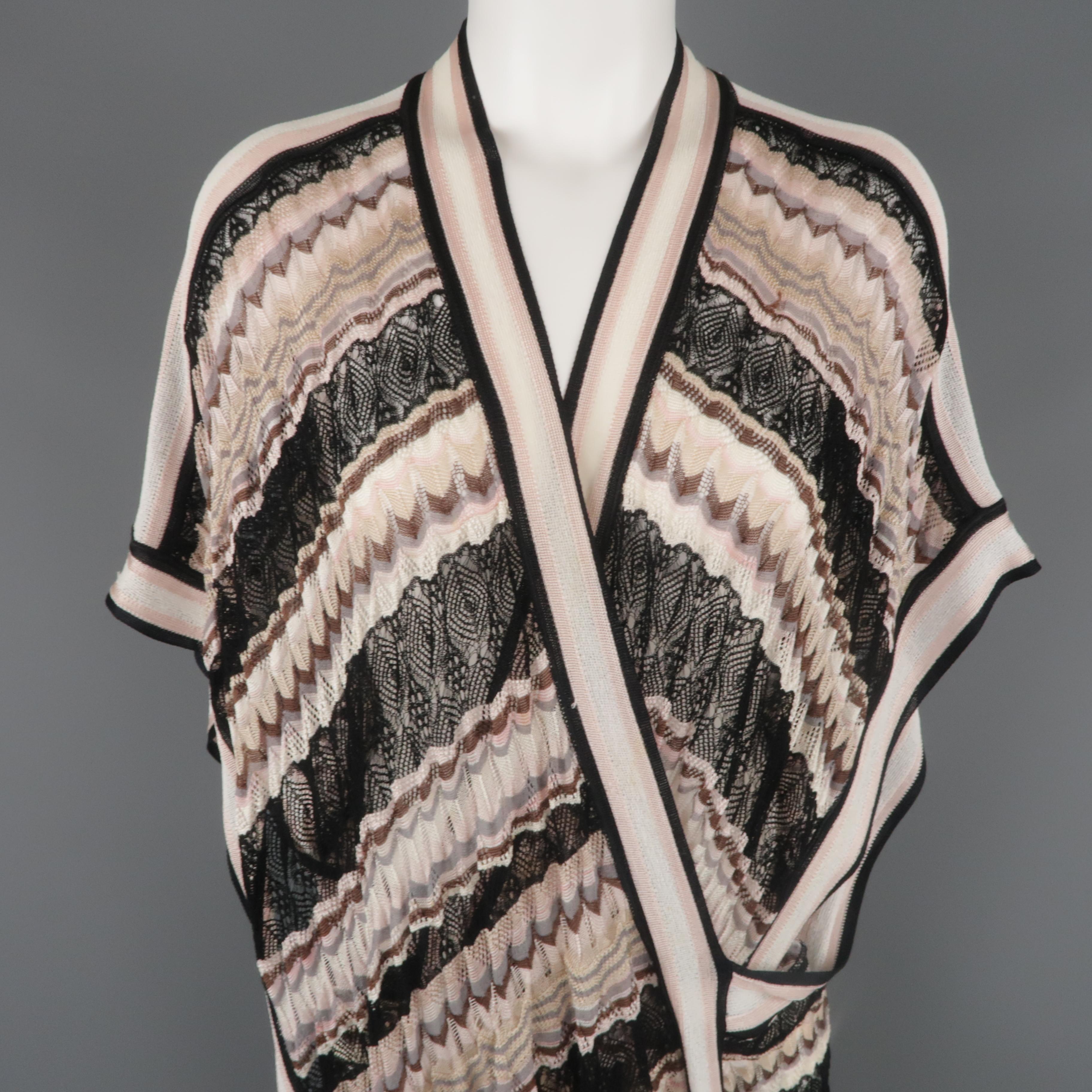 MISSONI sweater comes in light pink, taupe, cream, and black lace mesh textured silk blend knit with a deep V neck, wrap construction, open cape sleeves. Made in Italy.
 
Excellent Pre-Owned Condition.
Marked: S
 
Measurements:
 
Shoulder: 32