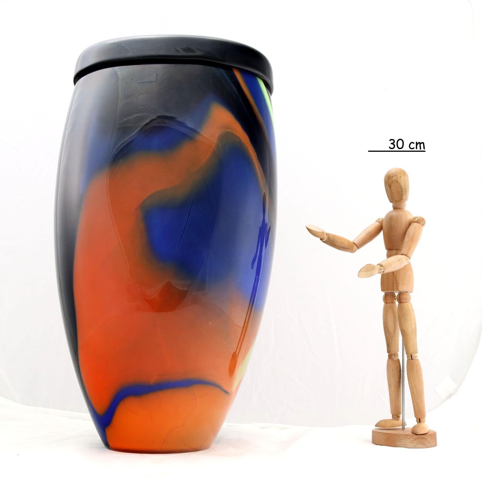 Multi-colored glass vase. The vase is branded 