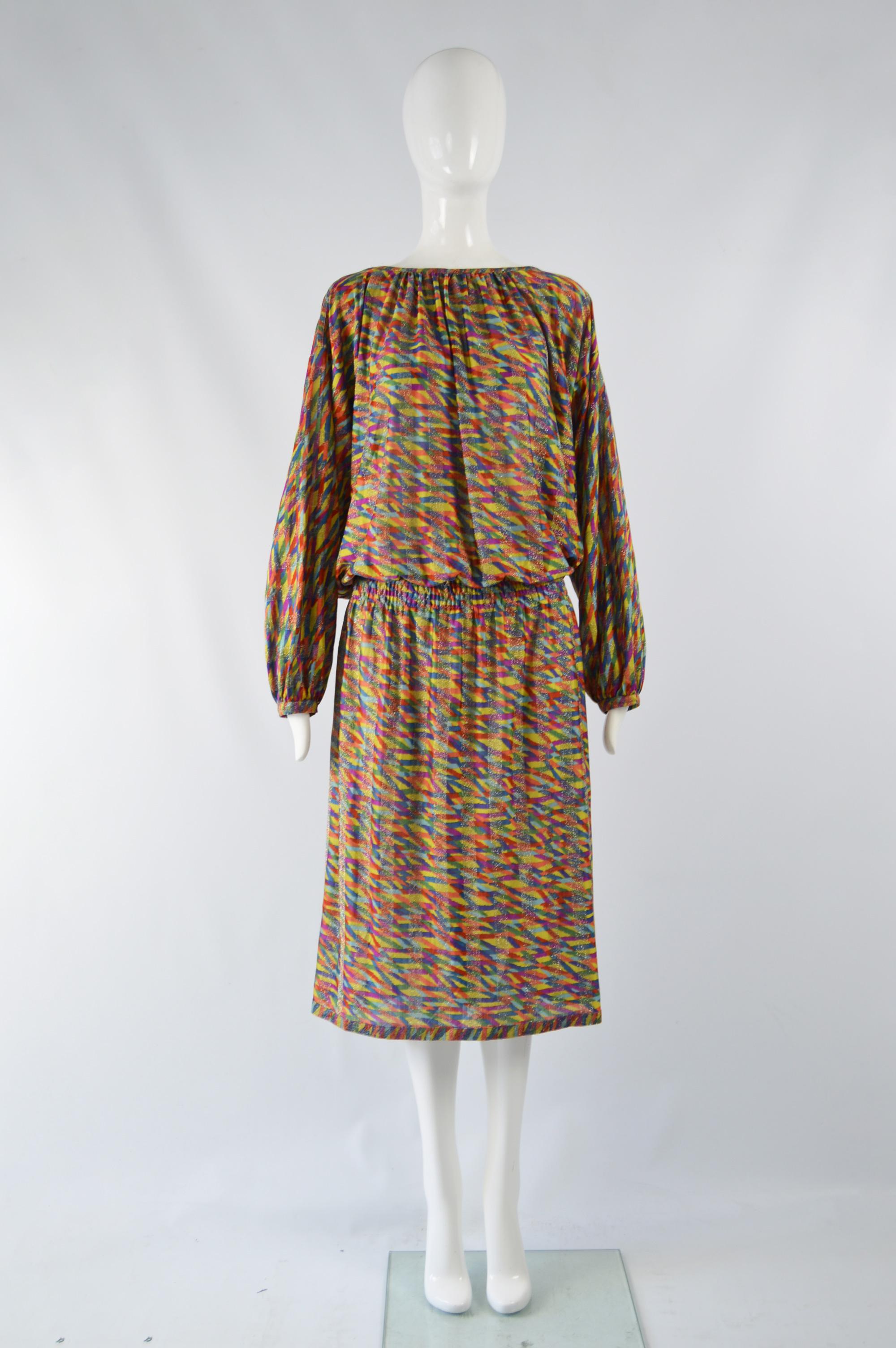 An incredible and rare vintage Missoni dress from the late 80s. In a rainbow patterned silk knit with silver, sparkly lurex stripes throughout for a glamorous evening look. It has an elasticated waist and loose, blouson fit on top. 

Size: Marked