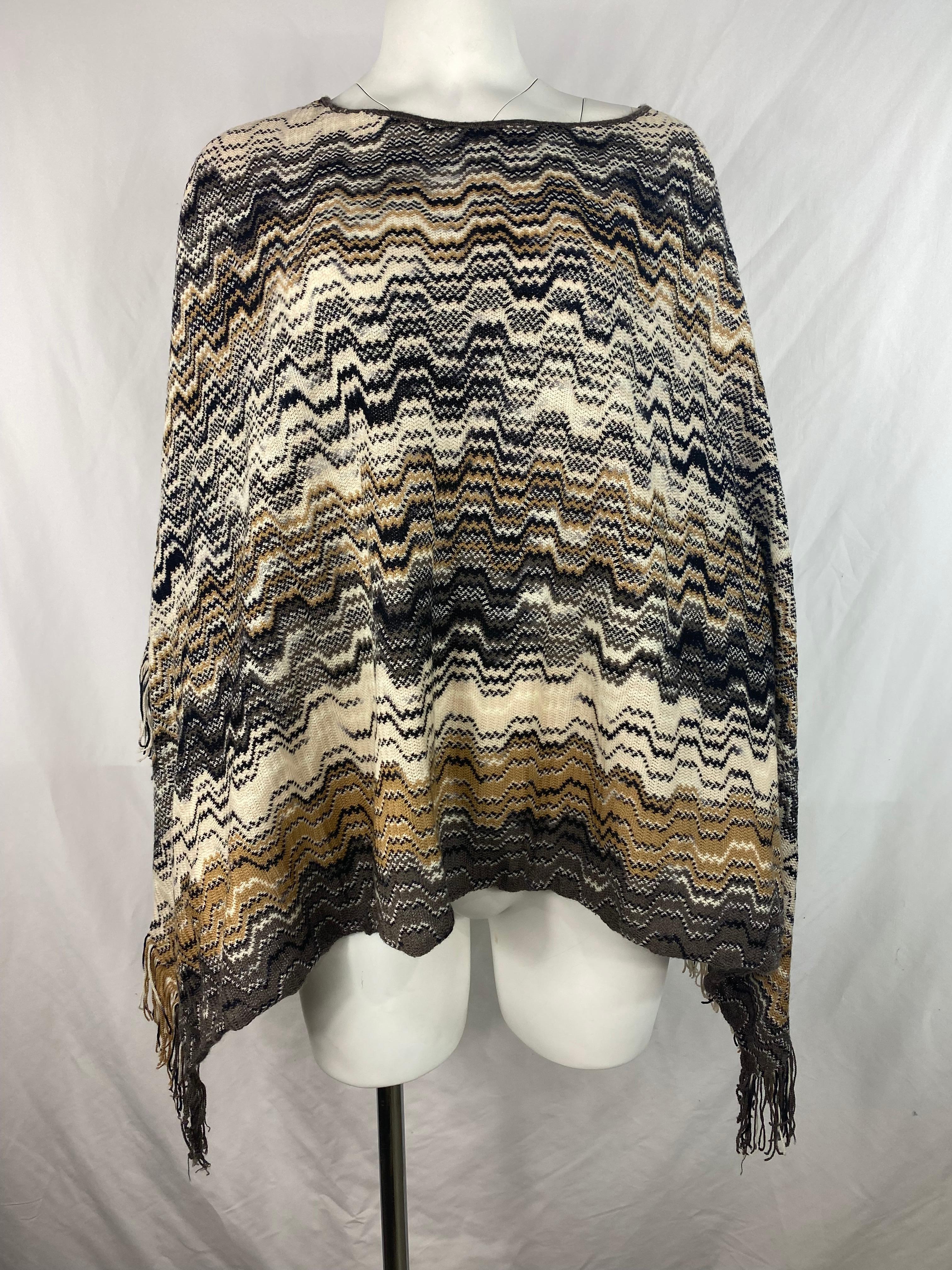 Product details:

The poncho features black, white, grey and brown colors, geometric patter with fringes on the bottom.