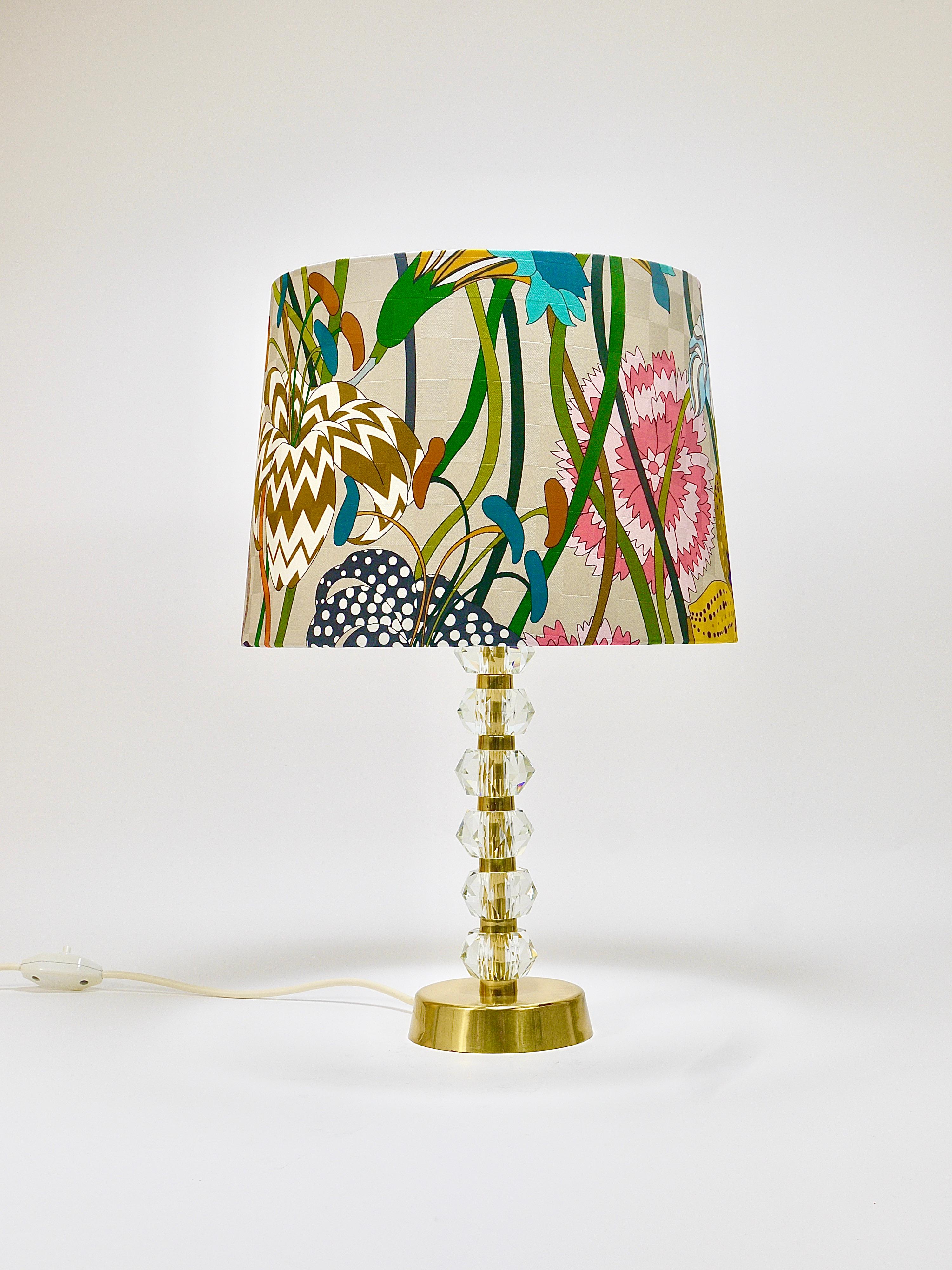 A beautiful midcentury table or side lamp, executed in the 1970s by Bakalowits & Söhne in Vienna, Austria. The lamps has a round brass base, it is very solid and has huge faceted crystals stacked with brass spaces on its neck. In very good condition