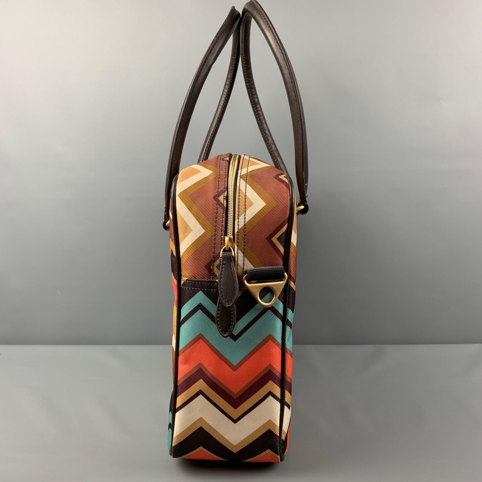 MISSONI x Target bag comes in a multi-color chevron print polyester featuring a tote style, top handles, leather trim, inner pocket, detachable cross body strap, and a top zipper closure. 

Very Good Pre-Owned Condition.

Measurements:

Length: 15.5