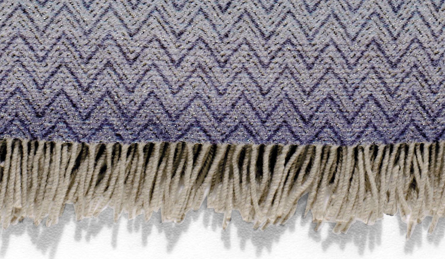 Throw in shaded wool blend with lurex applications and iconic Missoni geometric chevron print. Throw in shades of blue with neutral tone fringe trim. Presented in a branded gift box. Perfect for adding an elegant touch to any bedroom or living