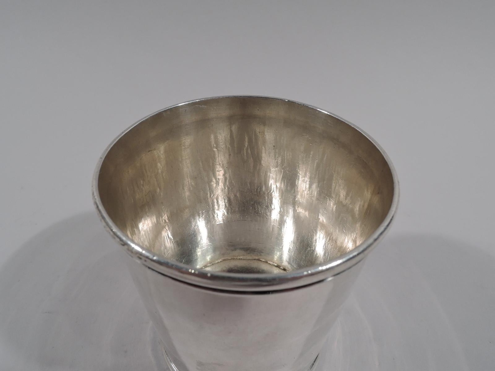 American coin silver mint julep cup. Made by George G. Schoolfield in Columbia, Missouri, circa 1850. Straight and tapering sides and molded rim and foot. Handwork visible on interior. Marked “G.G.Schoolfield.Col.Mo”. Weight: 4 troy ounces.