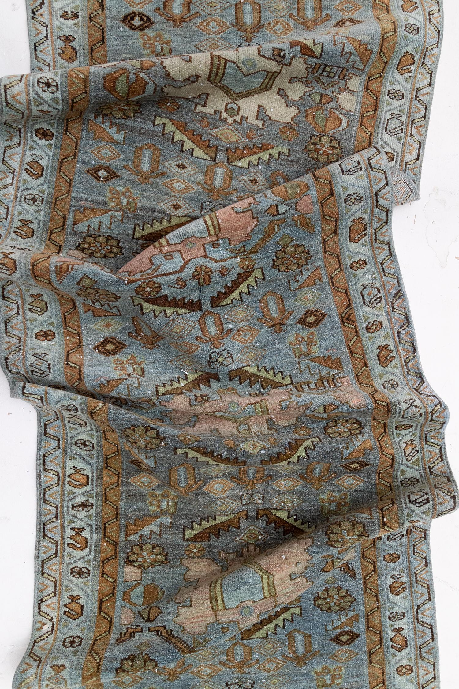 Age: Circa 1940

Colors: mist blue, pink brown, olive

Pile: medium- low.

Wear Notes: 1

Material: Wool on Cotton.

Beautiful vintage Oriental Hamadan with a nice soft pile in a misty blue tone. Soft pink accents. Harmonious with large