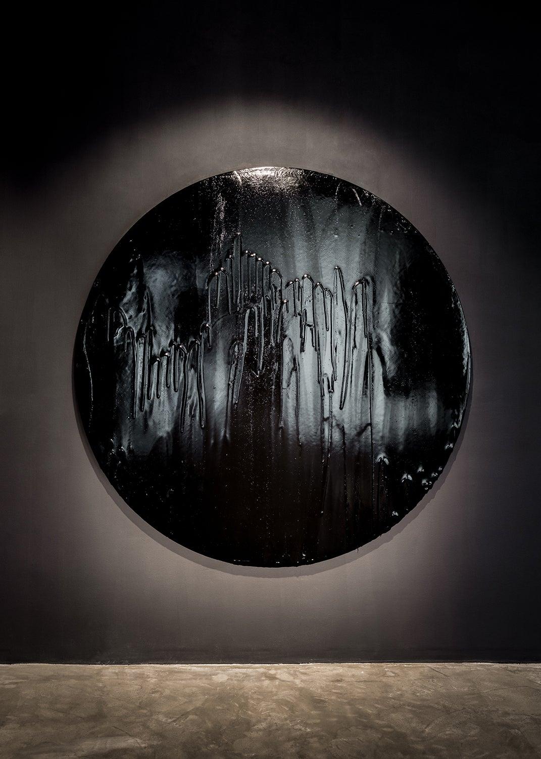 The dynamics of transformation is a driving concept and process behind Biagi’s work, in particular, the transformative power of coating everyday objects with layers of viscous tar. With his series of round paintings, the transformative power of tar