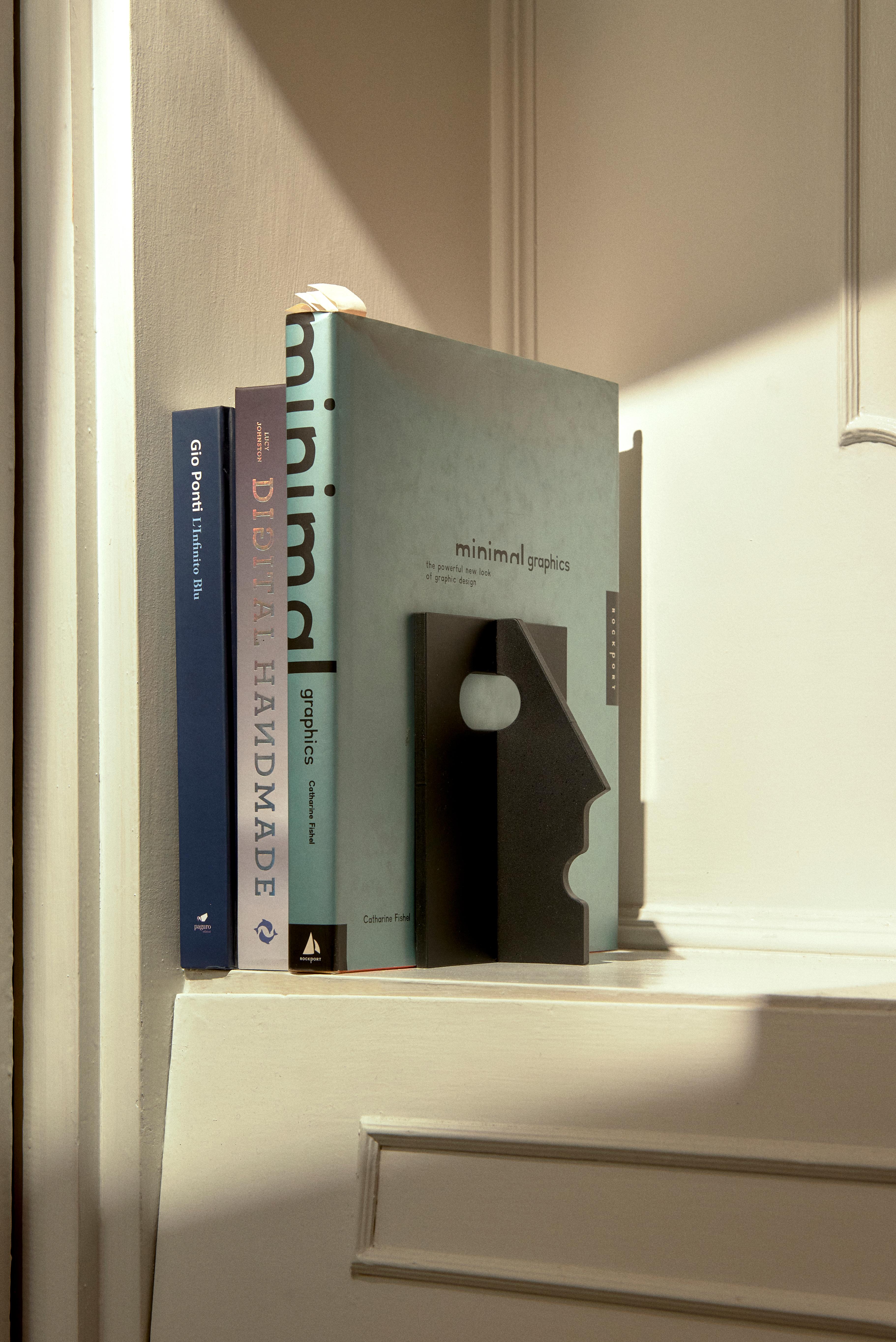 Mister T Bookend by Rampinelli Edizioni
Designed by Philippe Tabet
Dimensions: D 6.3 x W 12 x H 16 cm.
Materials: Steel.

PHILIPPE TABET
Mister T takes shape from a semi-finished product commonly used in construction. The ‘T’ section of a beam