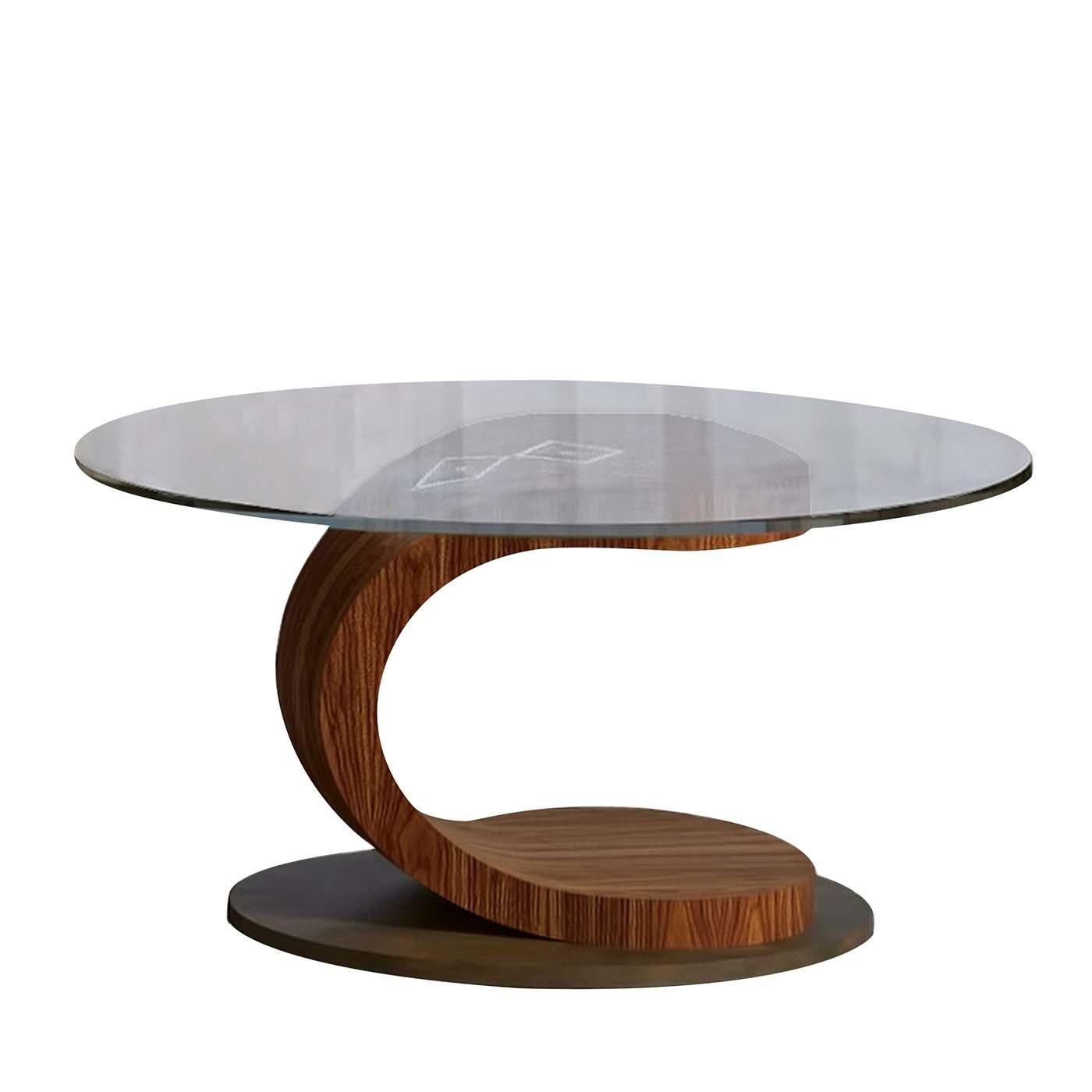 This chic coffee table plays with line and form to bring an artistic touch to the home. The design is defined by its curved Canaletto walnut leg, exuding an effortless allure with its sleek curved profile. Set on a satin bronze base and finished