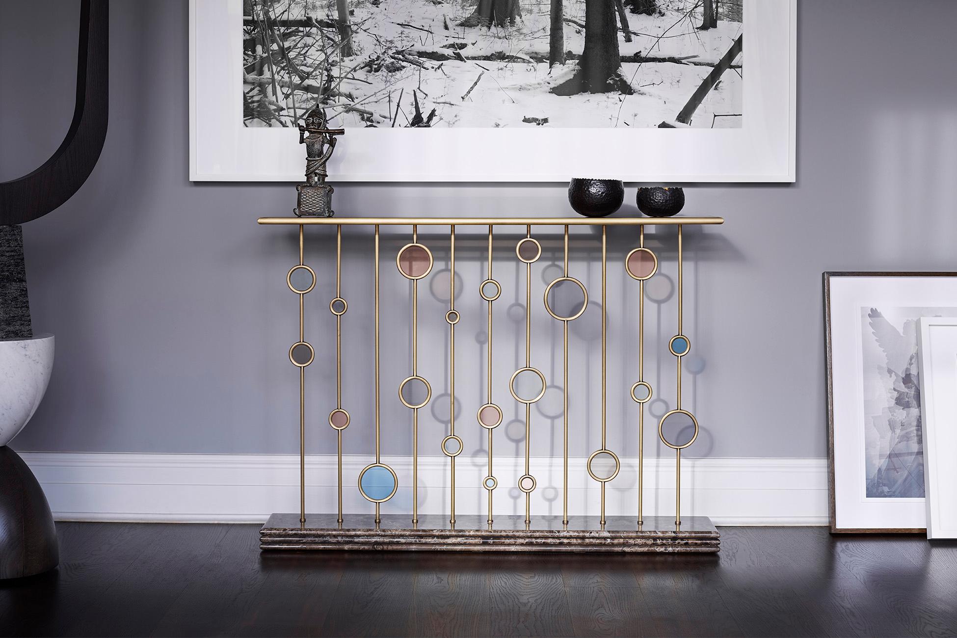 Contemporary Handcrafted Console/Fire Screen by BelBar Studio 

Misty Morning console / fire screen is a composition of ‘dewdrops’ in coloured glass encased by brass rings and placed along brass ‘stems’. They are supported by a dark emperador marble