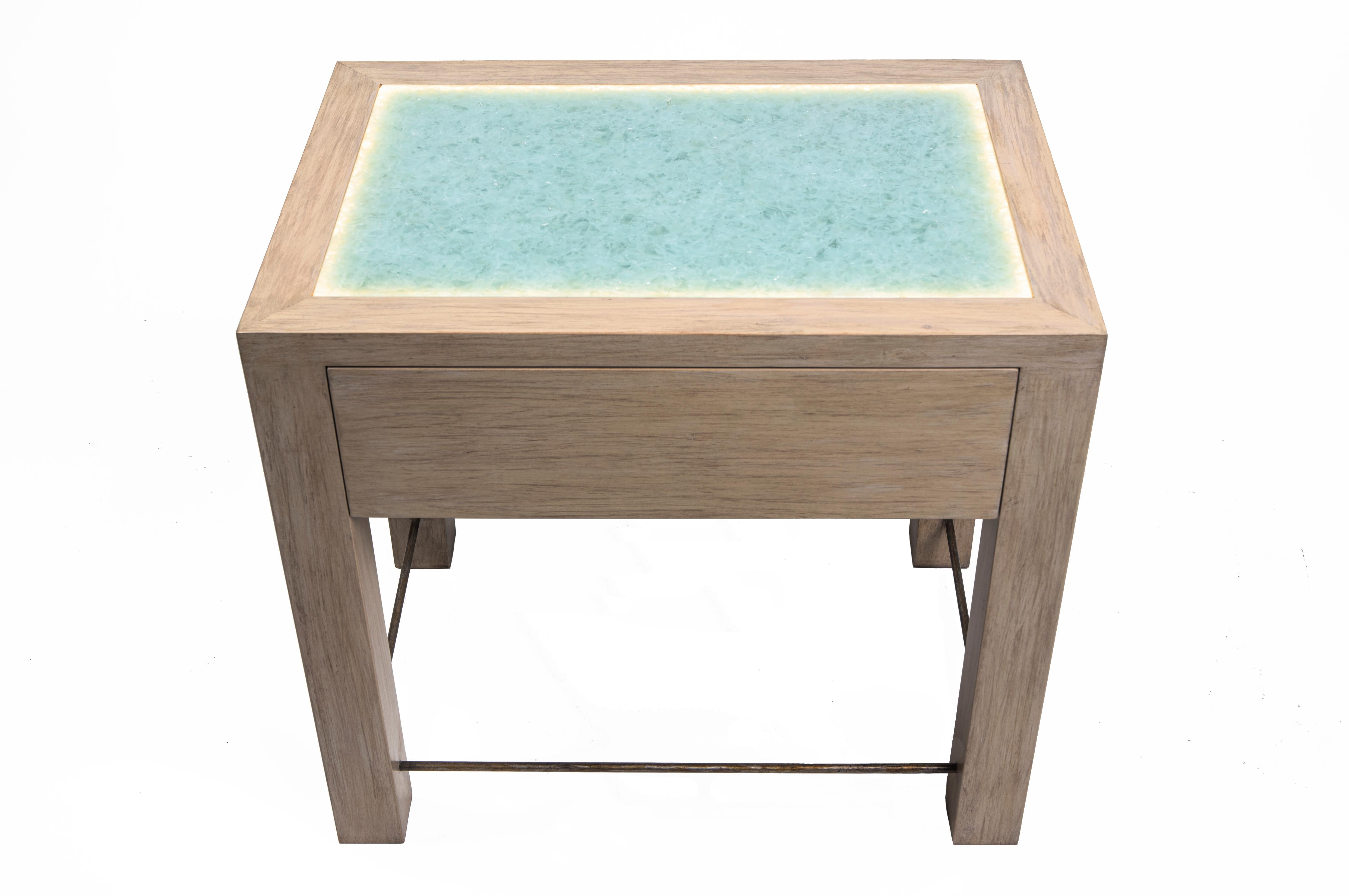 Eliminate the need for bedside lamps and add a warm glow to any bedroom with the innovative Misty Nightstand. Custom-crafted with built-in LED lighting and touch close drawers, this piece is free of hardware to better showcase its beautiful recycled