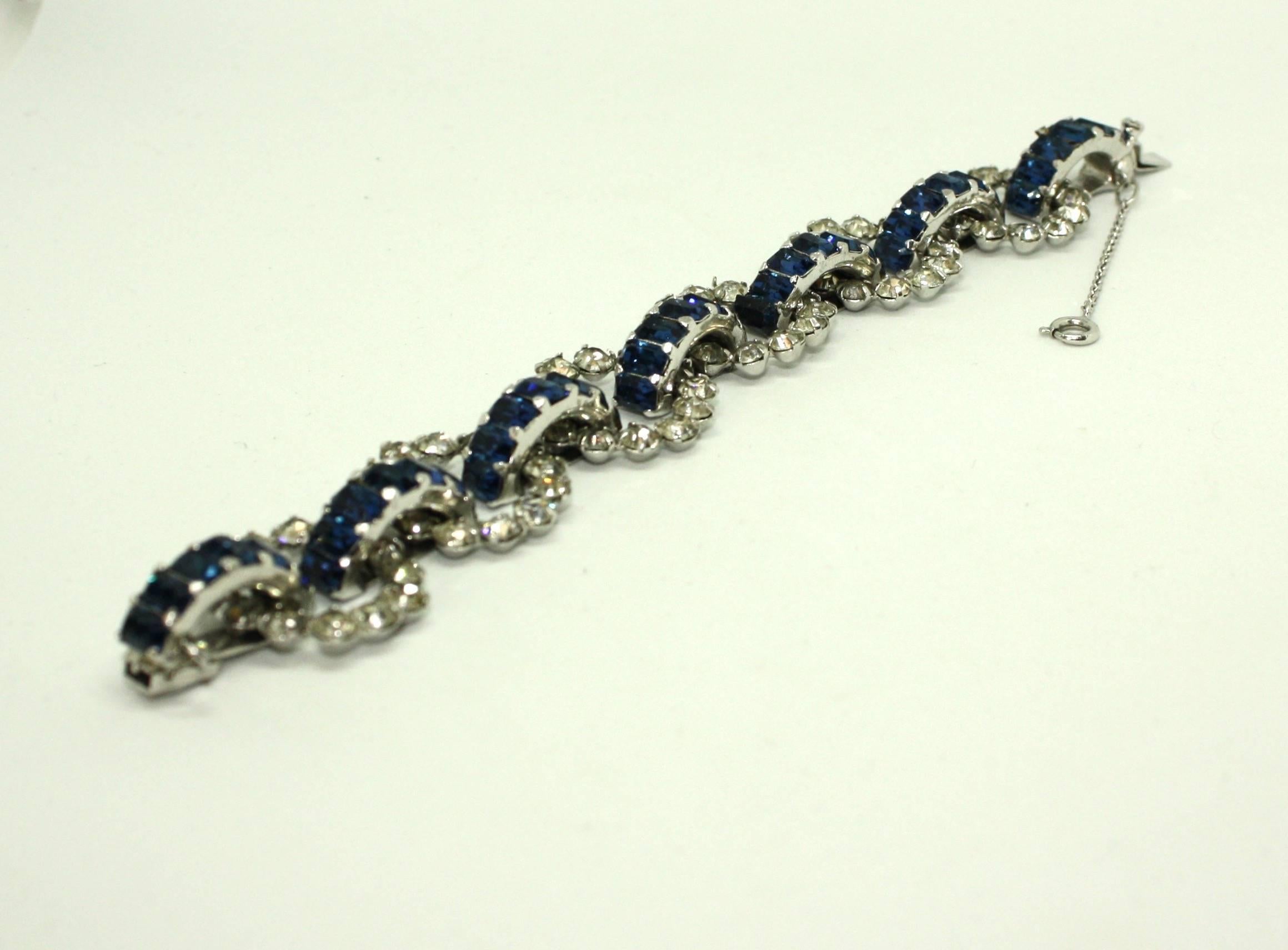 A beautiful sapphire blue and white diamante stone bracelet by Mitchel Maer for Christian Dior. Claw set stones circular stones are linked by bridges of beautiful deep blue baguettes. The bracelet features a safety chain and box-tongue clasp. It is