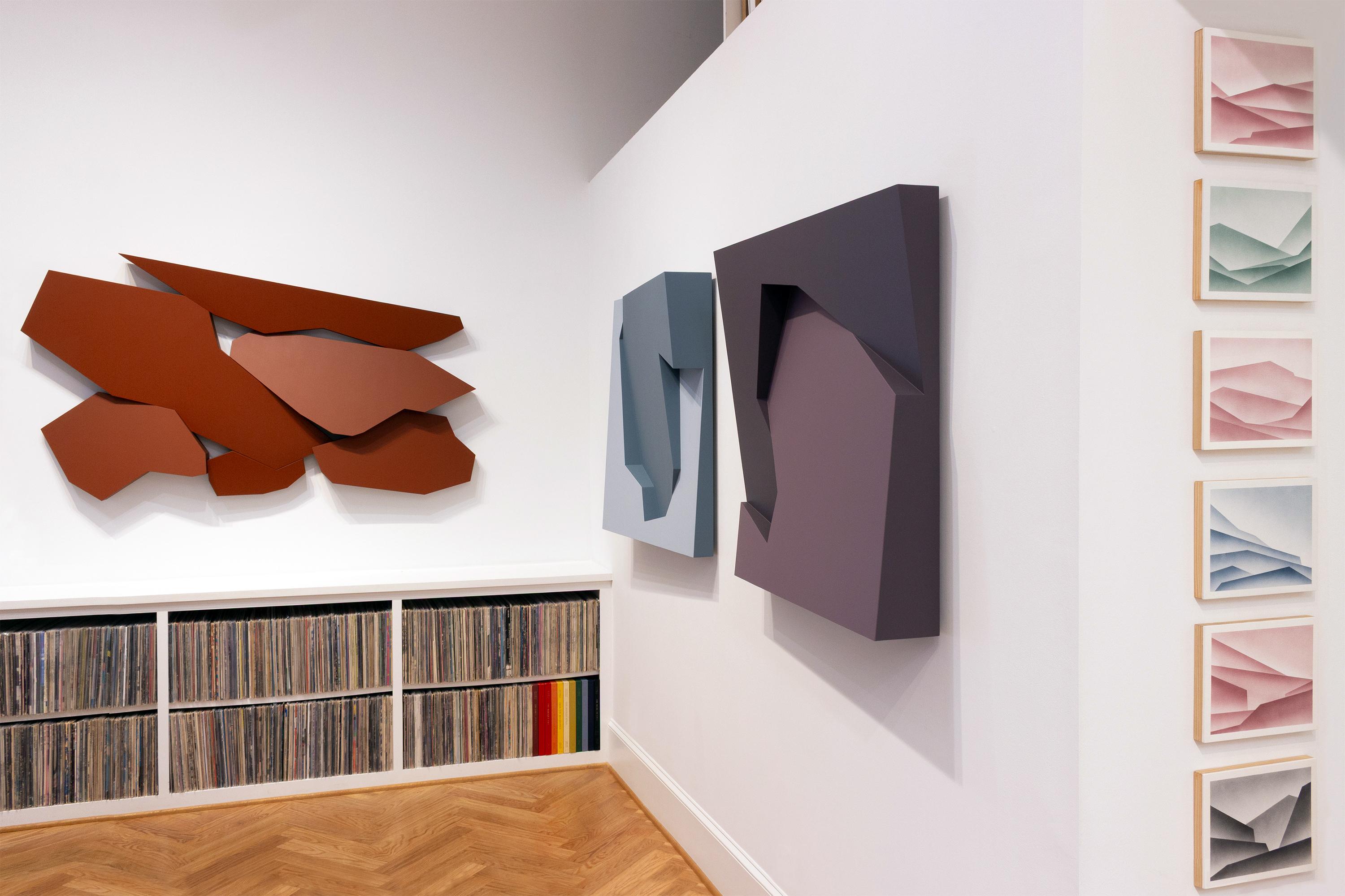 This geometric wall sculpture features purple hues. 

Atlanta-based artist Mitchell Biggio’s “Fault” is a series of complex three-dimensional wall sculptures that navigate the expansive interaction of shifting elements within our memories and frames