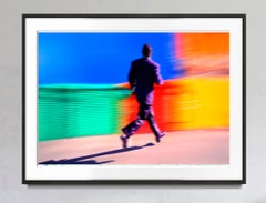 Black Businessman Running Against a Colorful Background