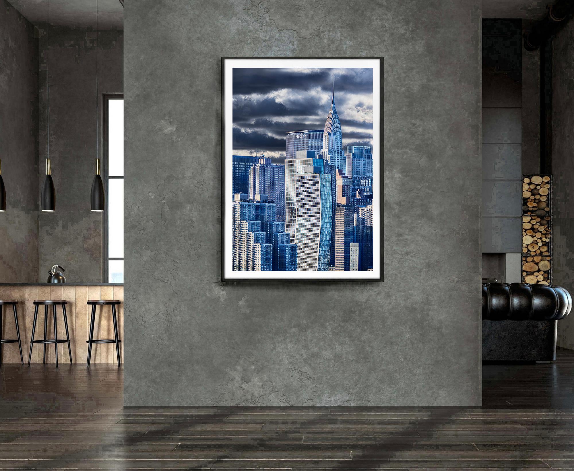  A moody, silver and grey light, composed of harmonious hues, caresses the Chrysler Building, while subtle highlights shimmer off the glass facades that frame it.  Photographer Mitchell Funk specializes in creating drama out of the ordinary.  It's