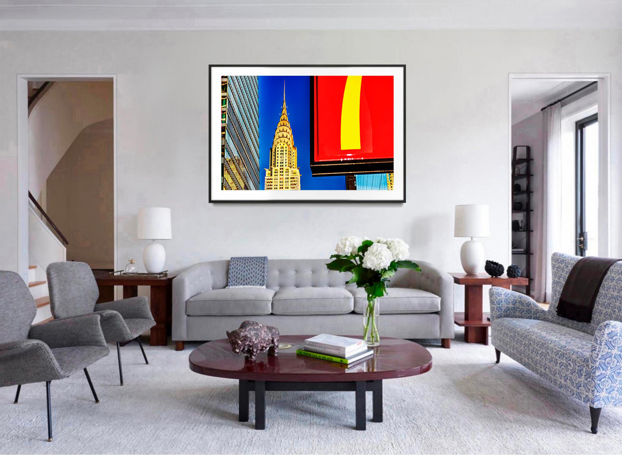 For 53 years, Mithcell Funk has been photographing the art deco beauty of the Chrysler Building. In this work, Funk frames the iconic spire between two other rectilinear shapes. On the left, there is a typical monochromatic glass skyscraper. On the