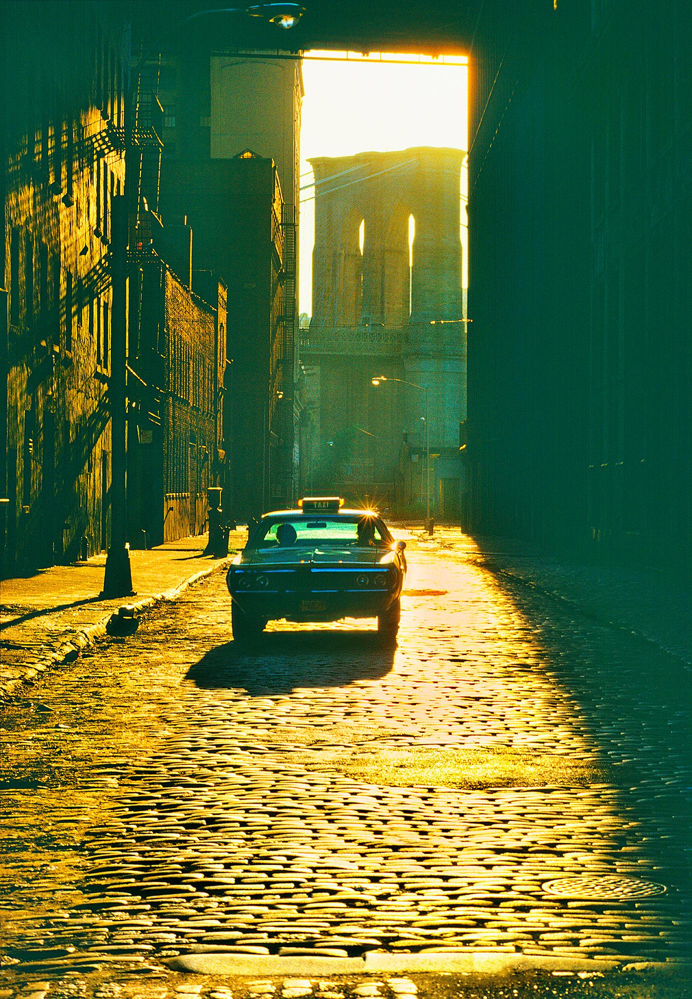 Mitchell Funk Landscape Photograph – Dumbo - Gold Brooklyn Bridge Cobblestone Street