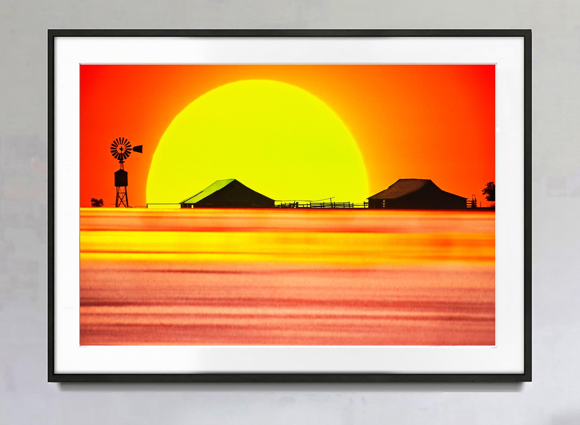 Dust bowl Texas Sunset with Dramatic Sky Windmill - Orange and Yellow landscape  - Photograph by Mitchell Funk