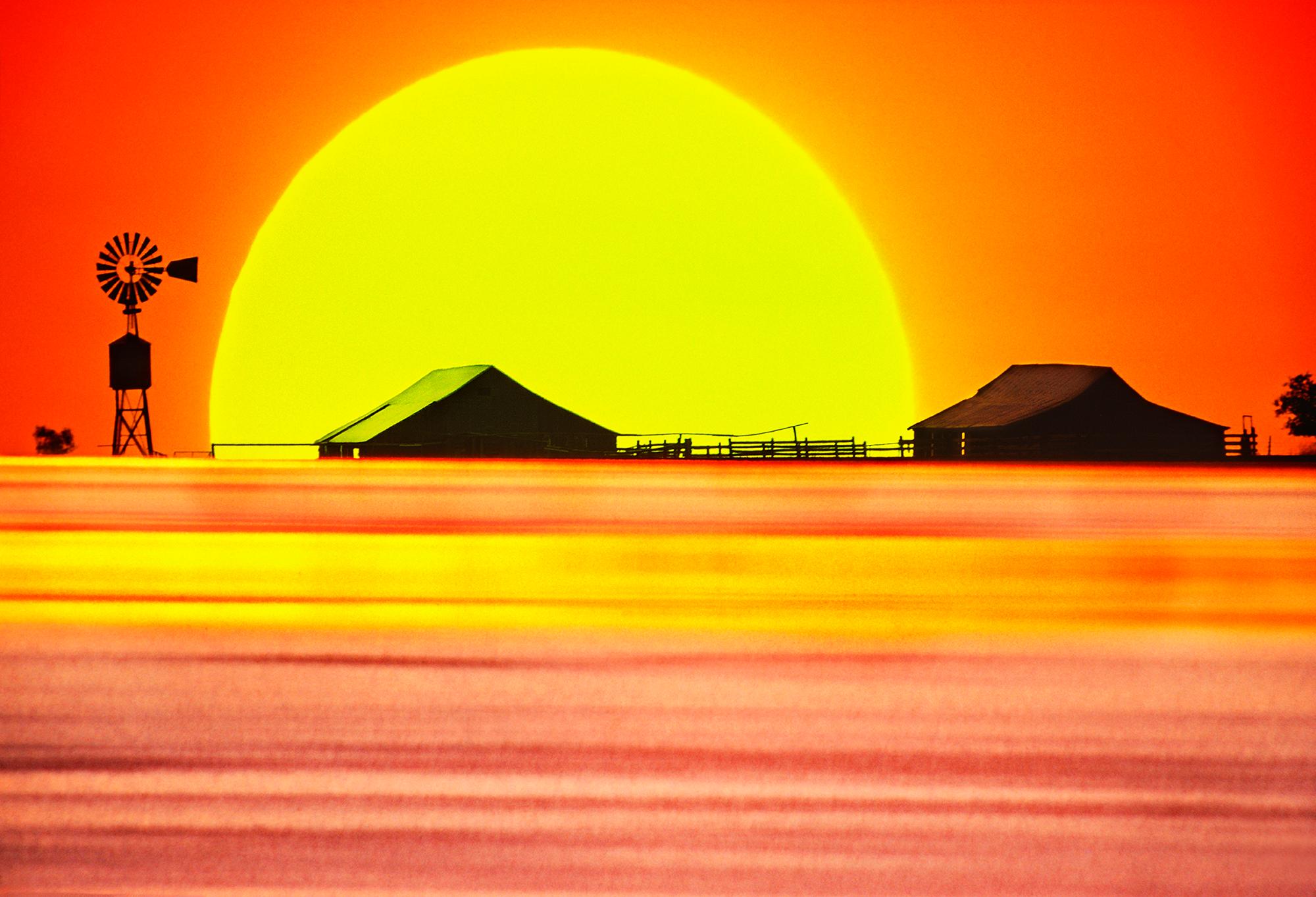 Bol à poussière du Texas coucher de soleil avec moulin à vent spectaculaire au ciel - paysage orange et jaune 