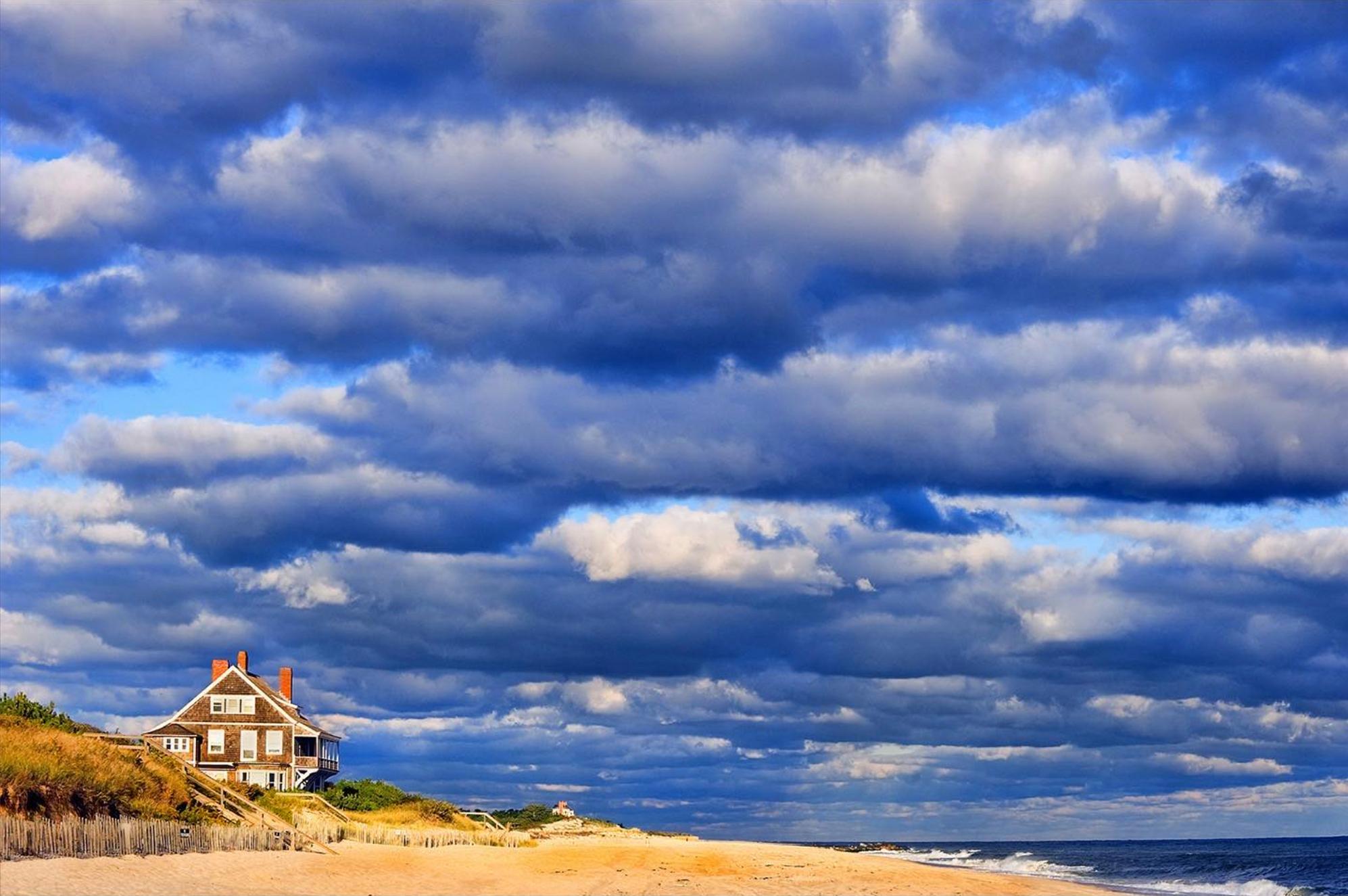 A single house juts out into a vast sky and sea of Long Island.  The image takes inspiration from the epic 19th-century paintings and the American West with vast unending sky and untamed landscapes.  Yet the composition is quite radical and