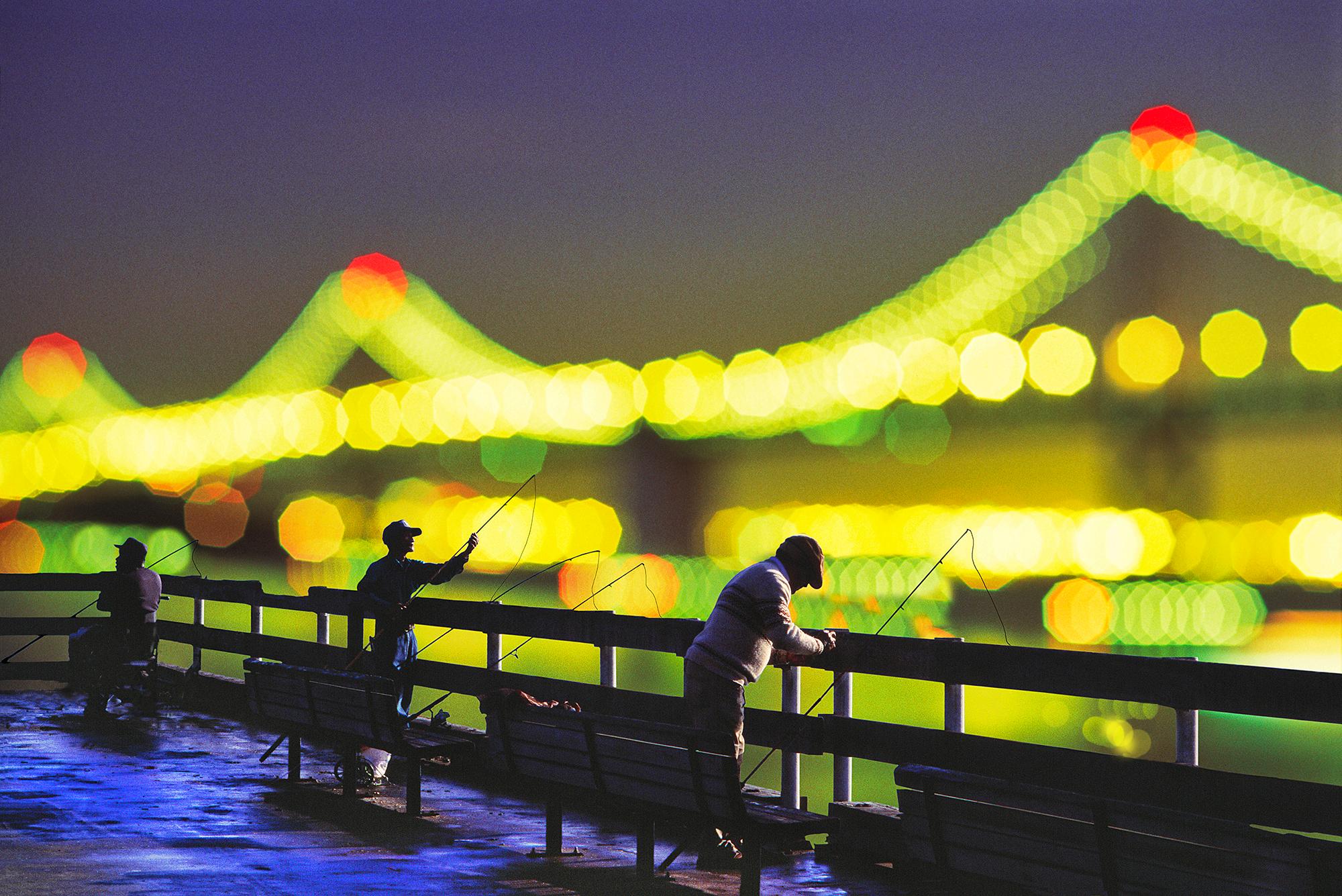 Mitchell Funk Landscape Photograph - We Are All Fisherman.   Figures and Out of Focus Lights San Francisco Bay Bridge