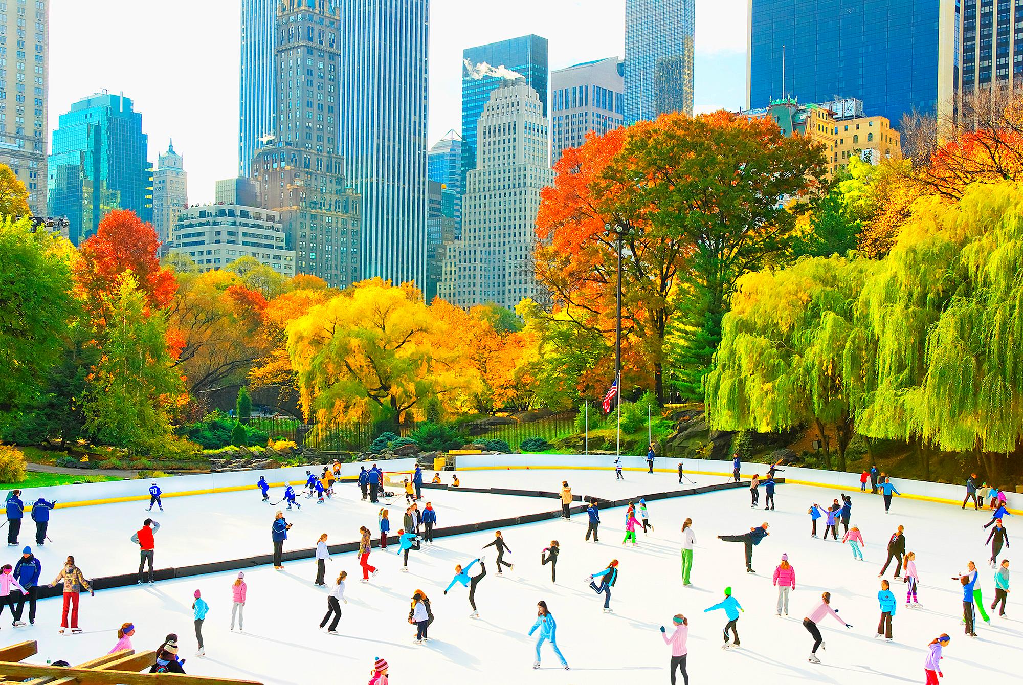 Ice Skaters in Central Park Rink  Panoramic view of the Skyline Autumn Colors