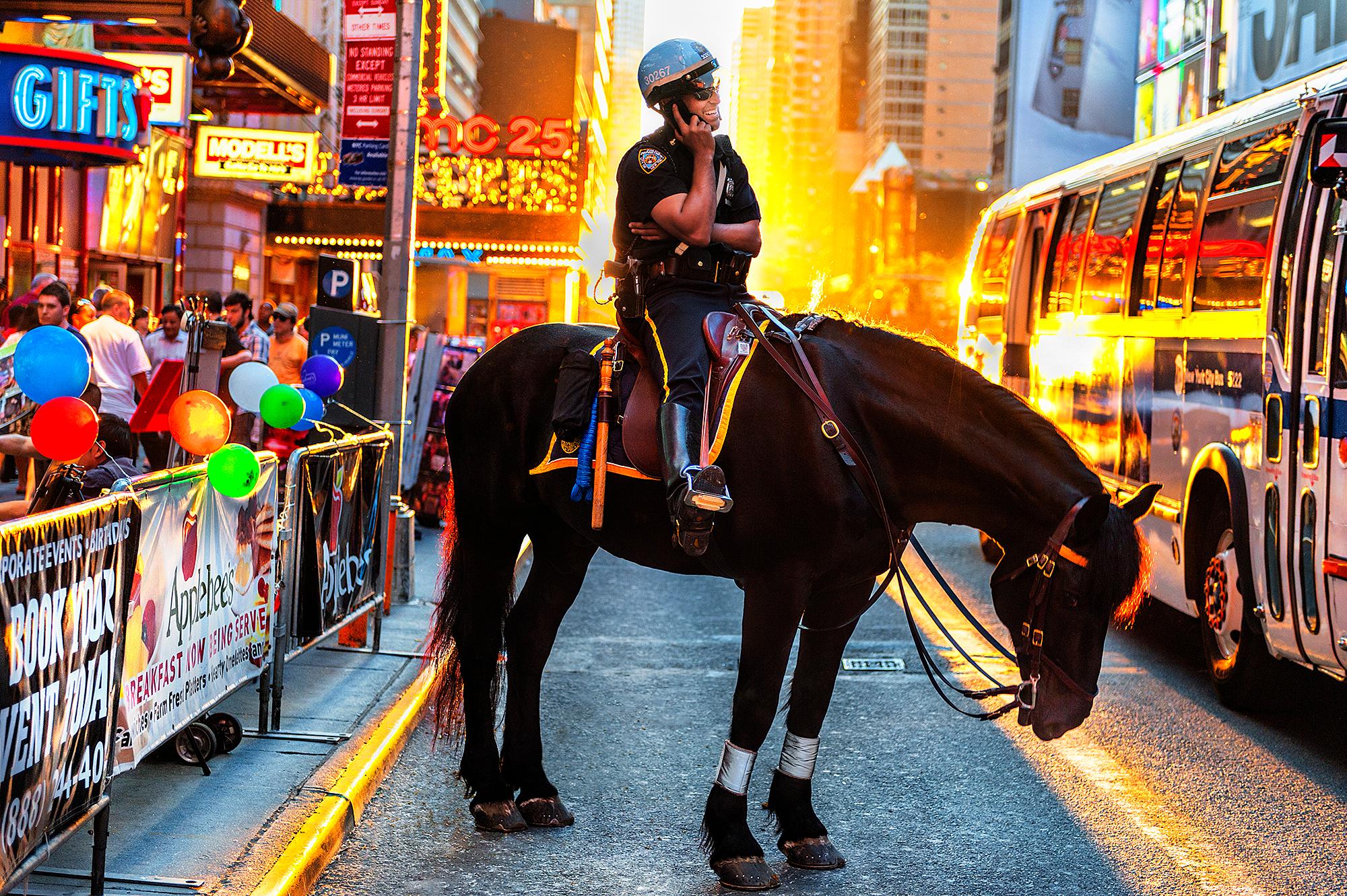 Mitchell Funk Portrait Photograph – Laughing Policeman on Horse 42nd Street Times Square Golden Light