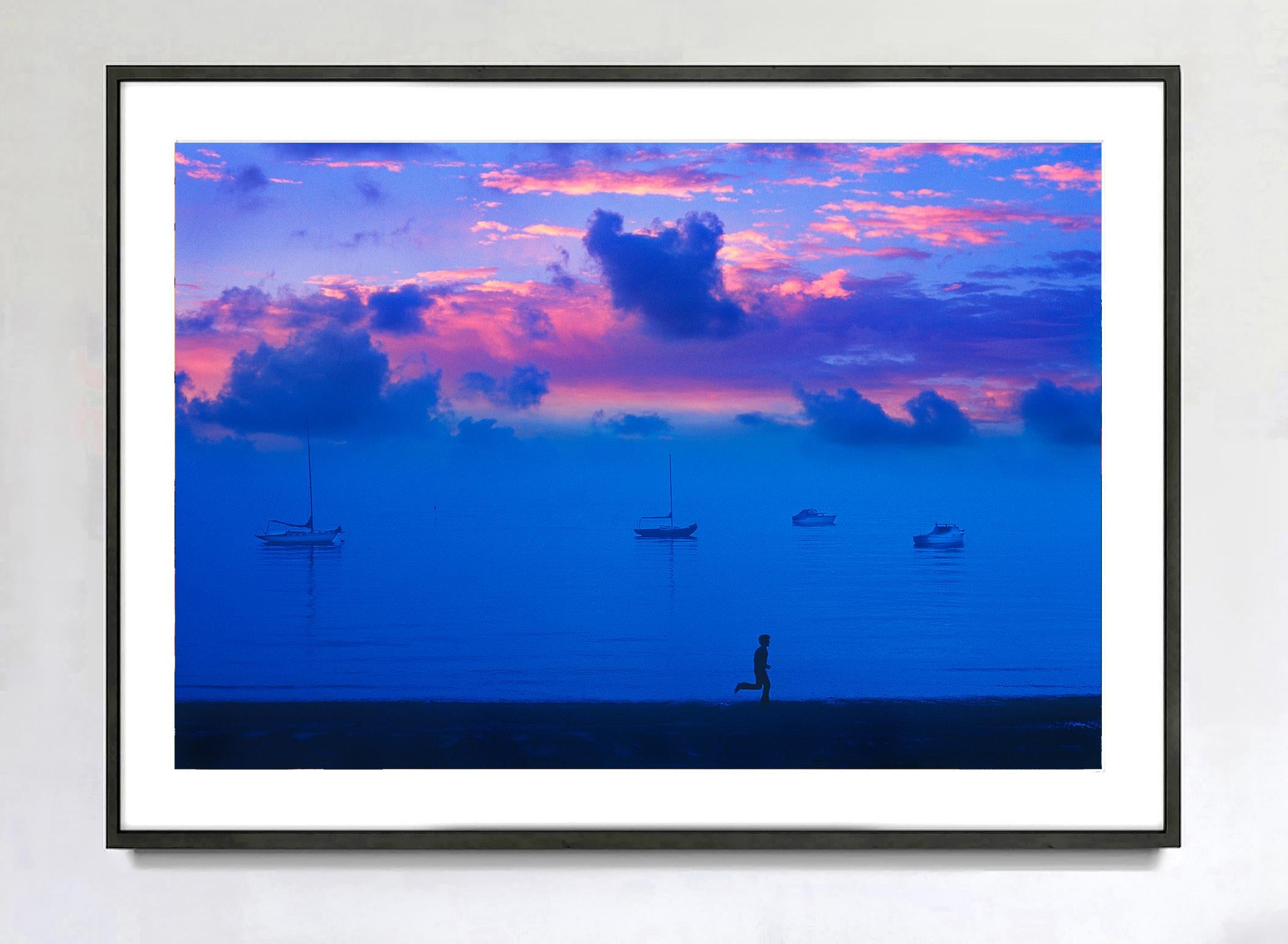 Cielo magenta al tramonto , Cielo sereno in blu e magenta  L'uomo che corre e le barche - Color Photograph Blu di Mitchell Funk
