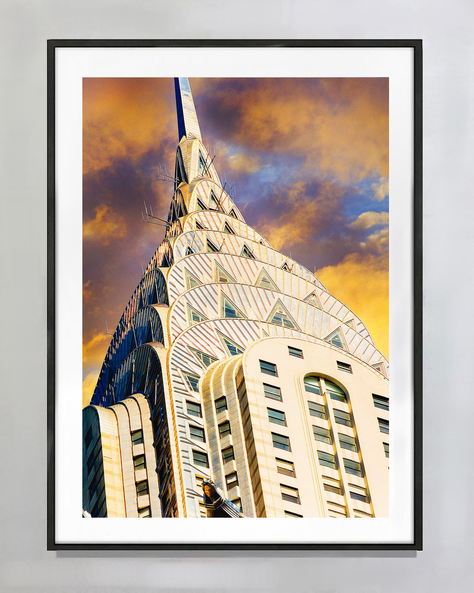 Die Nahaufnahme der Art-Déco-Turmspitze des Chrysler Buildings ragt majestätisch in einen stimmungsvollen Sepia-Himmel.  Die Betrachtung dieses Werks ist eine erbauliche Erfahrung. Es erfreut nicht nur das Auge, sondern weckt auch das ästhetische