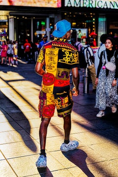 Man in Colorful African Theme Clothes Illuminated by Shaft of Light 
