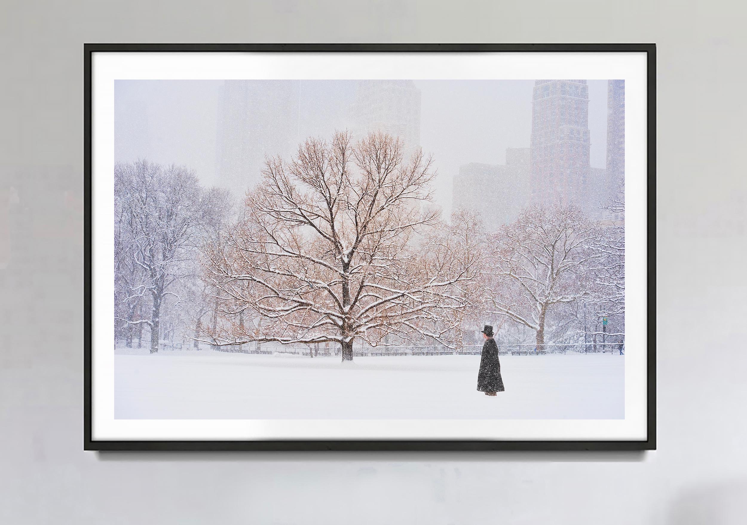Man mit Hut auf dem Oberschenkel im Central Park bei Schneefall  – Photograph von Mitchell Funk