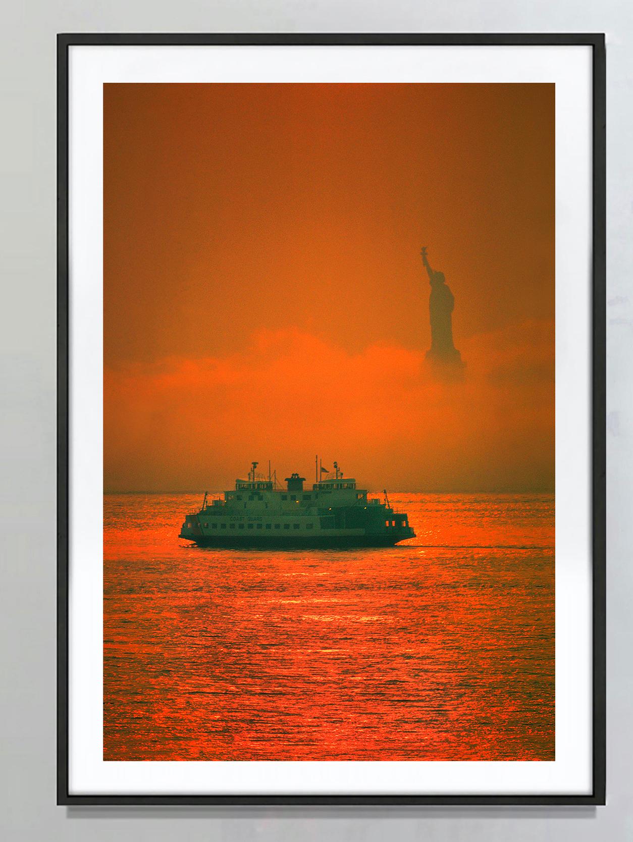 New York Fog with Statue of Liberty Orange Glow  - Photograph by Mitchell Funk