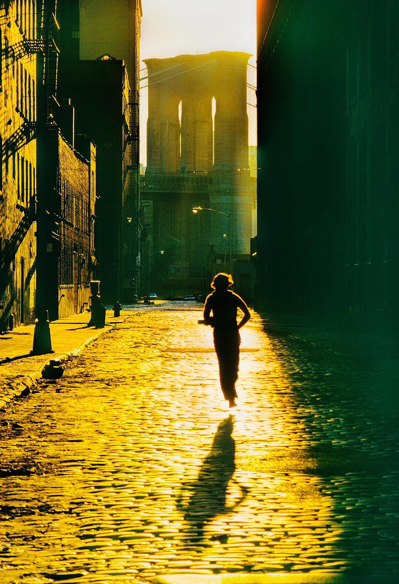 Floating Runner Glides Above Dumbo Cobblestone in Angelic Light