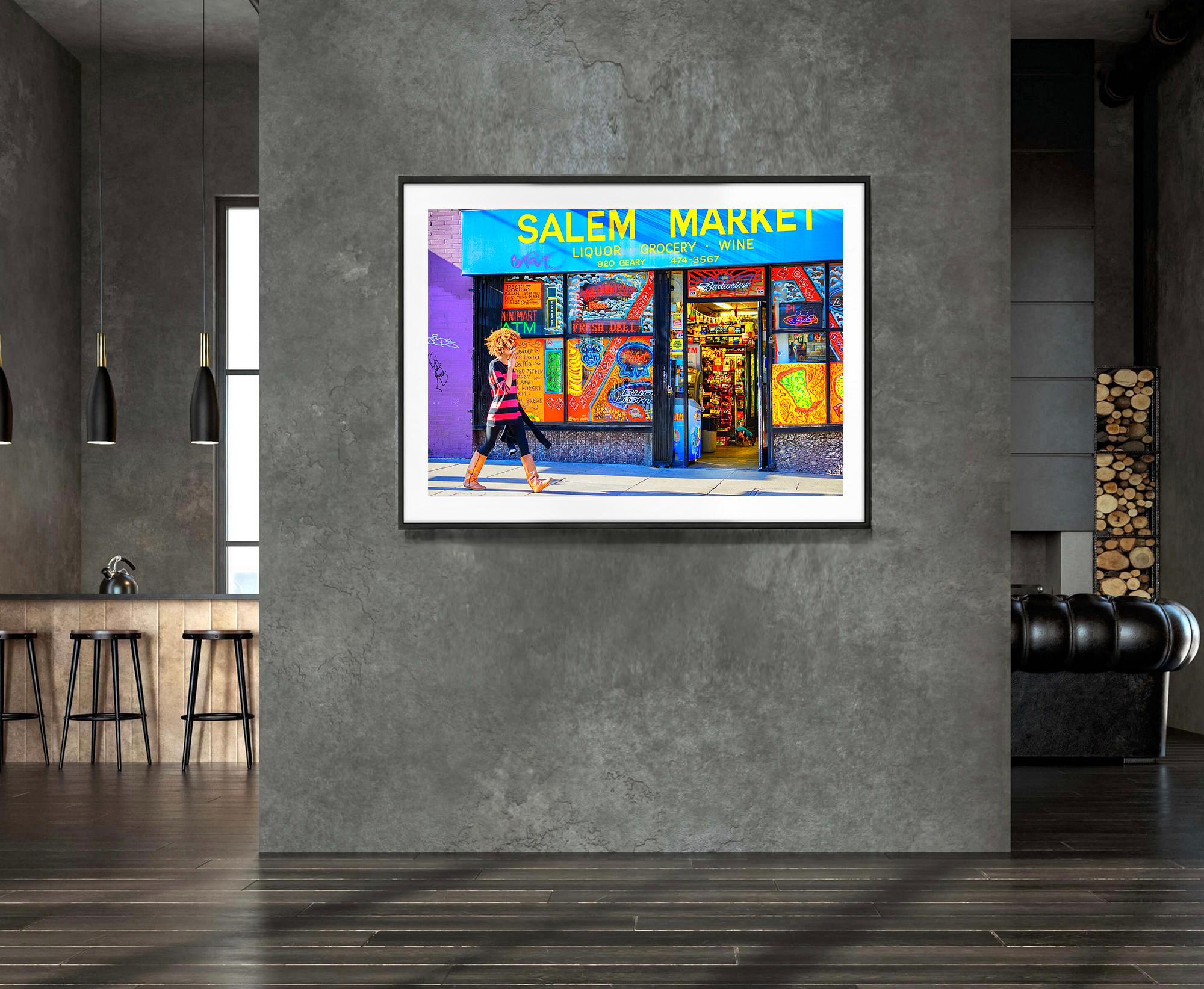  A colorful street scene in San Francisco's Tenderloin is captured as a hip young girl walks in front of a hyper-colored convenience store window. 
Photographer Mitchell Funk has approached on-location street photography with the same precision and