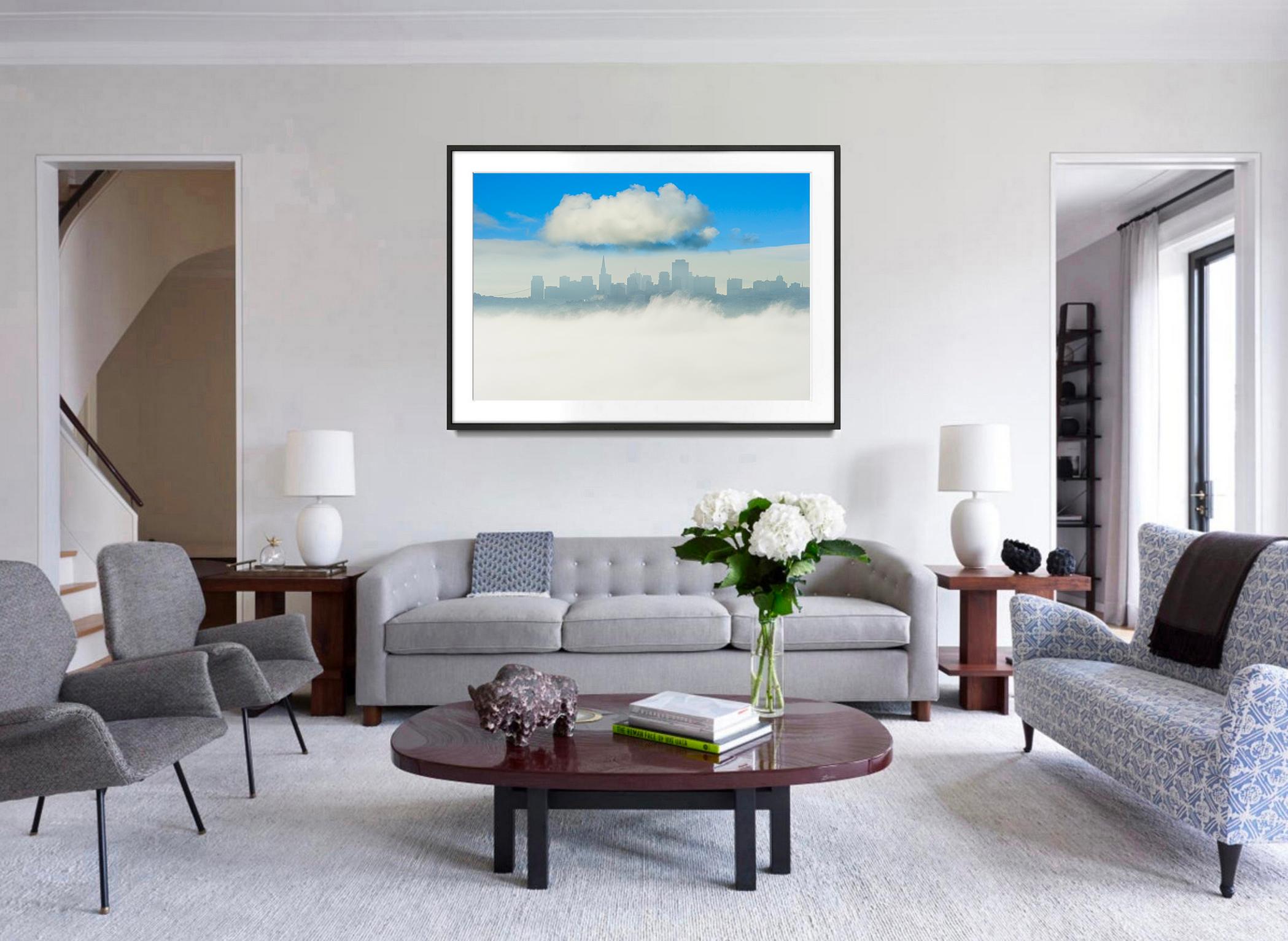 One big puffy cloud hovers over the skyline of San Francisco and is counterbalanced by a big puffy area of fog. The fine art photograph is Signed and dated and numbered lower left recto.  The photograph is of Edition 3 of 15, Printed later. 