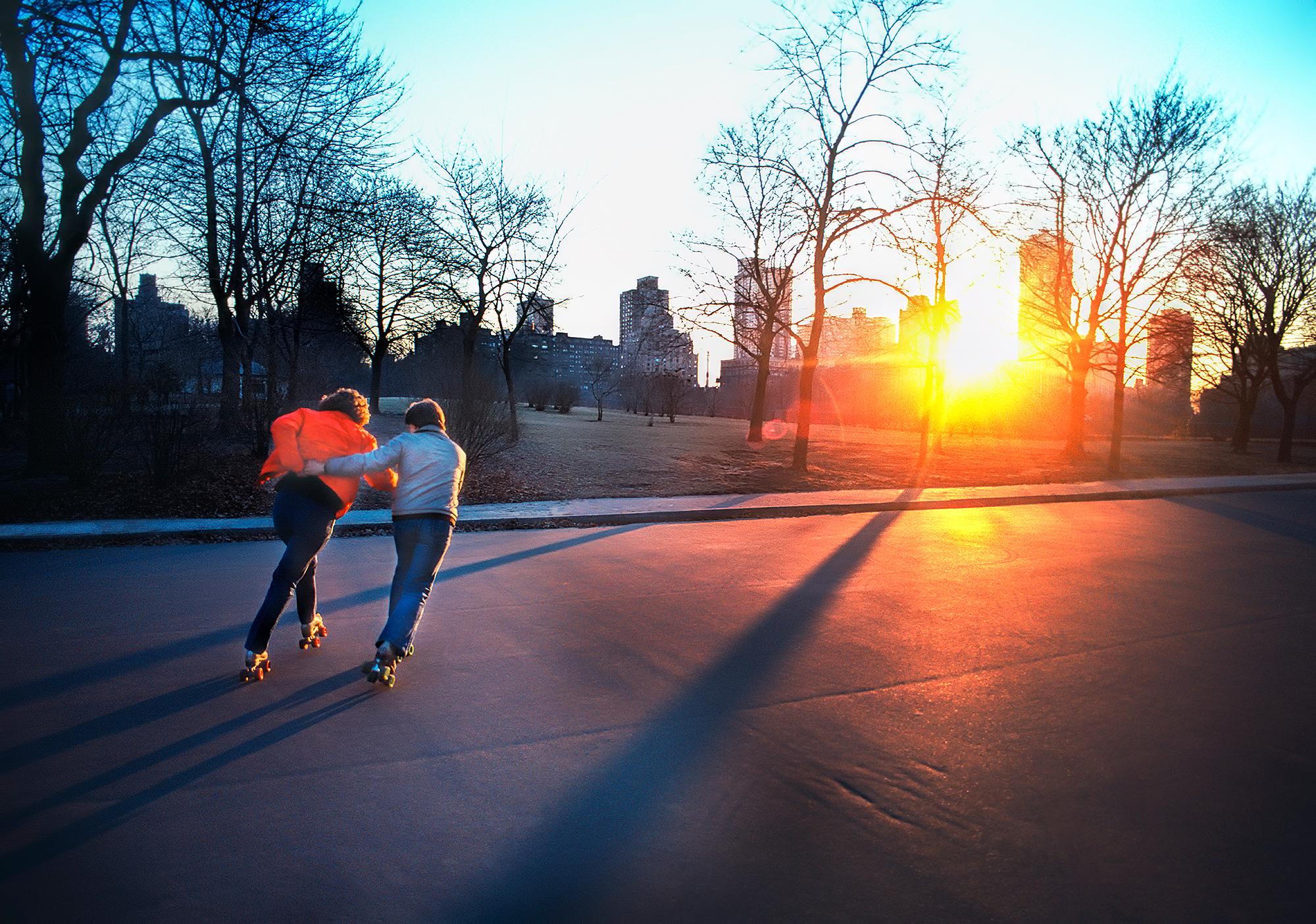 Mitchell Funk Figurative Photograph - Skaters in Central Park at Sunset