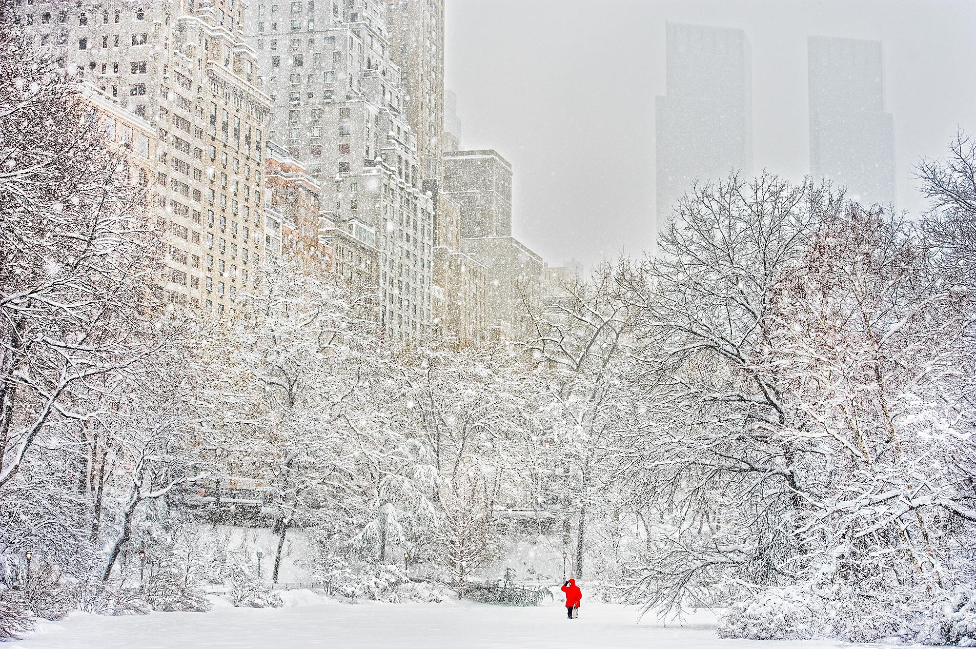 A dot of red in a sea of white captured by veteran street photographer Mitchell Funk.  The sub-text of this image is that in one of the world's most crowded places a person can be surrounded by complete emptiness.... providing the conditions are