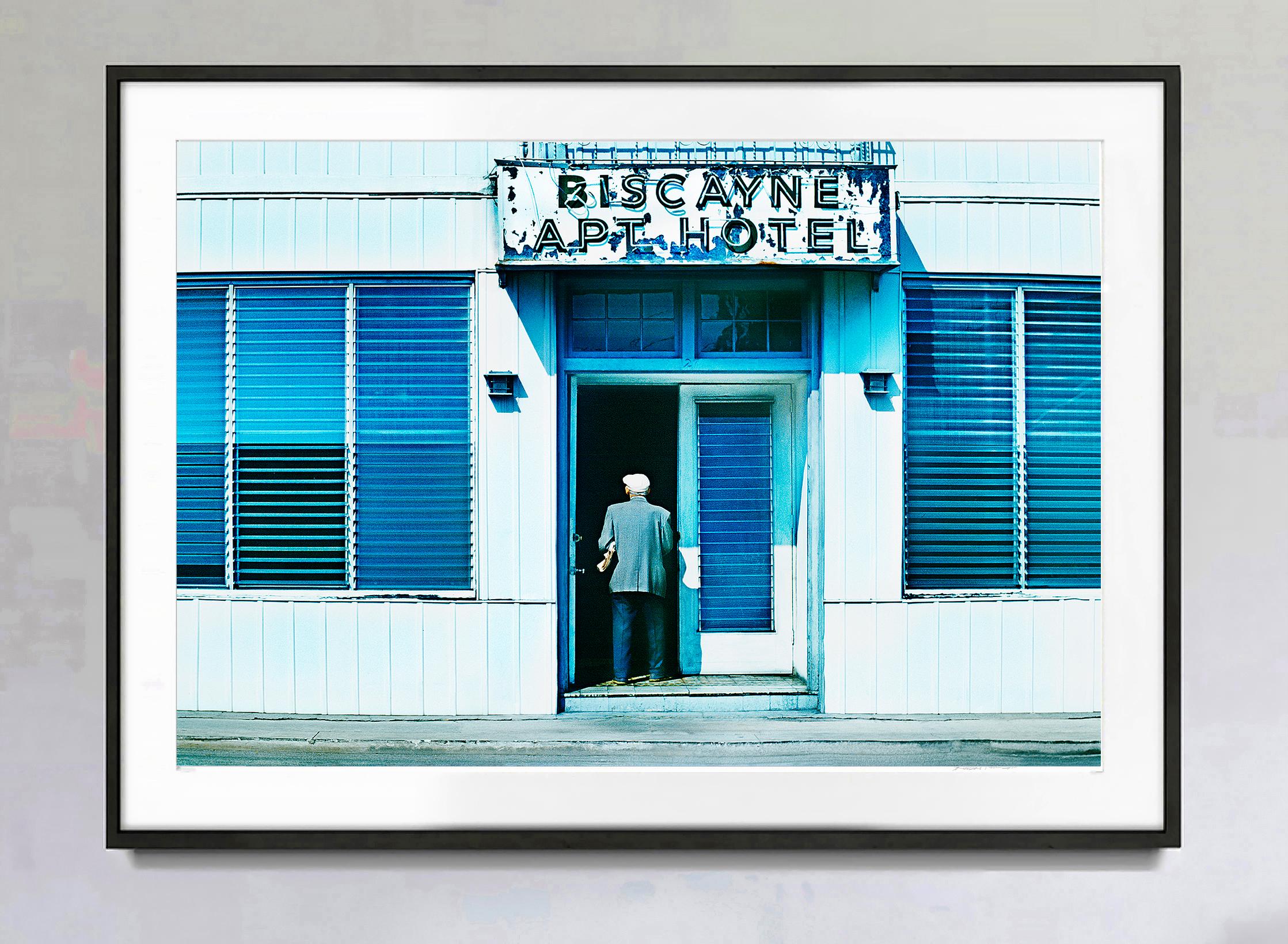 South Beach in the 1970s. Old Man Walking Enters Building - Old Miami Beach - Photograph by Mitchell Funk