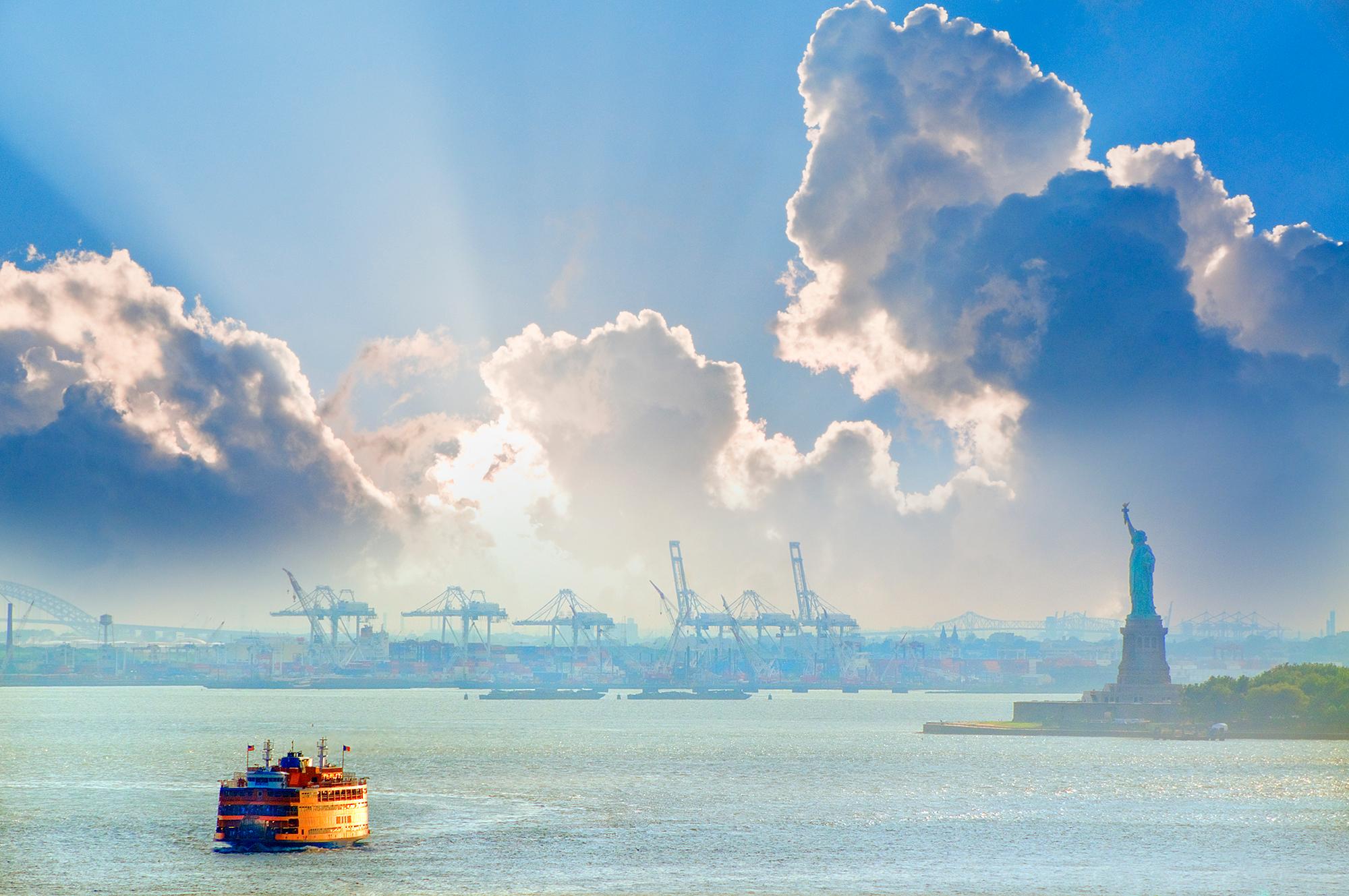 Statue of Liberty In New York Harbor with Burst of Light