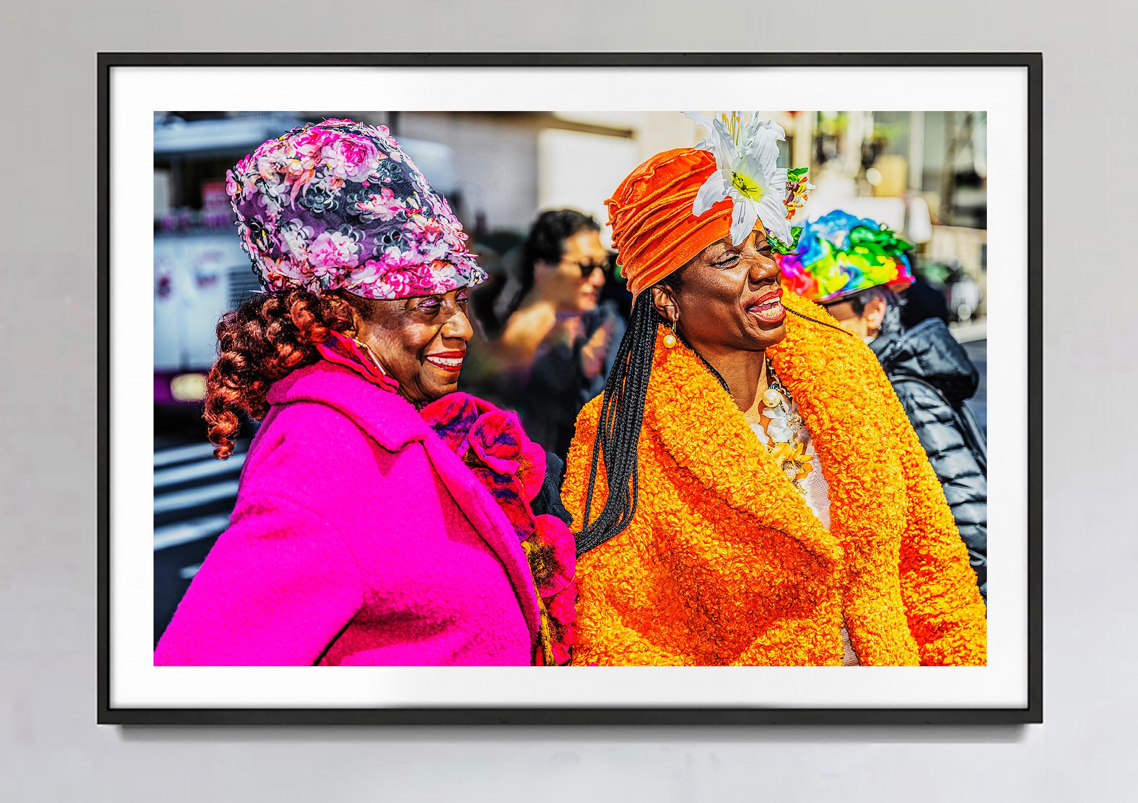 Two African American Women Shine in Pink and  Orange on Easter Day Parade  - Photograph by Mitchell Funk