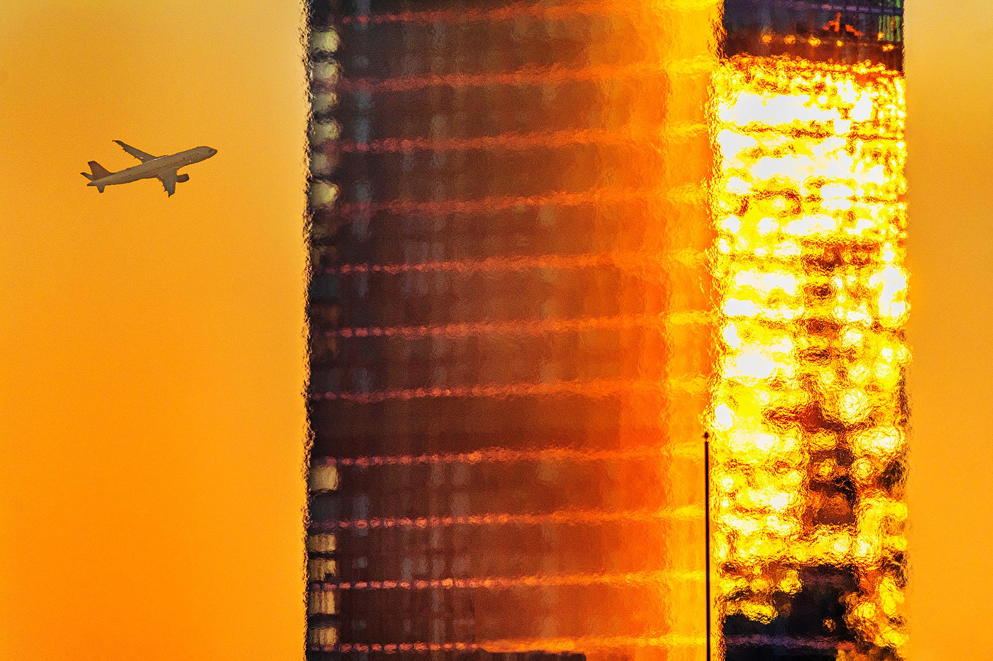 Mitchell Funk Color Photograph - Urban Landscape Golden Sky with Melting and Dissolving Glass Skyscraper