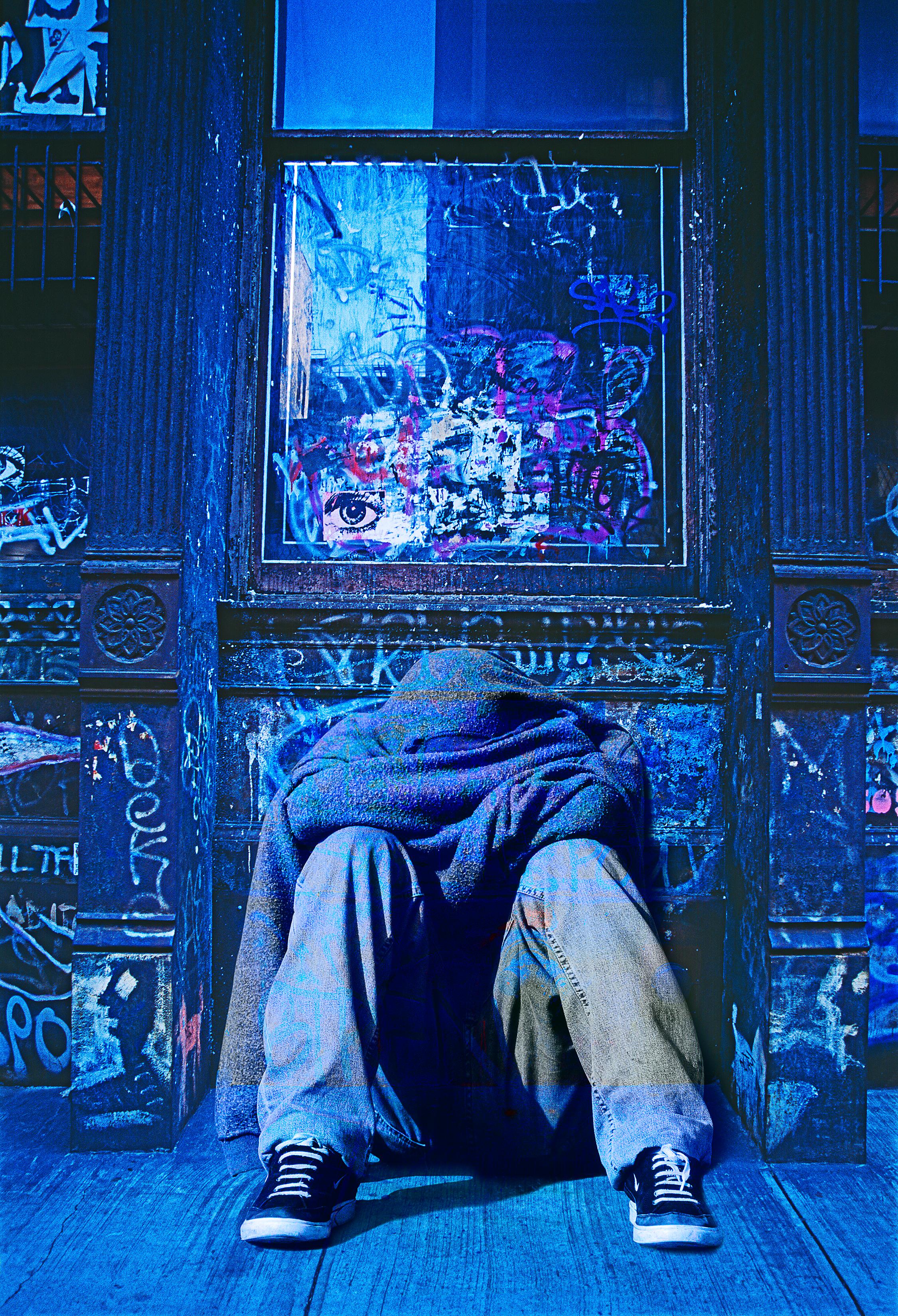 Mitchell Funk Abstract Photograph - Urban Melancholy Blue.  Motionless Young Man,  Graffiti  Wall in Soho