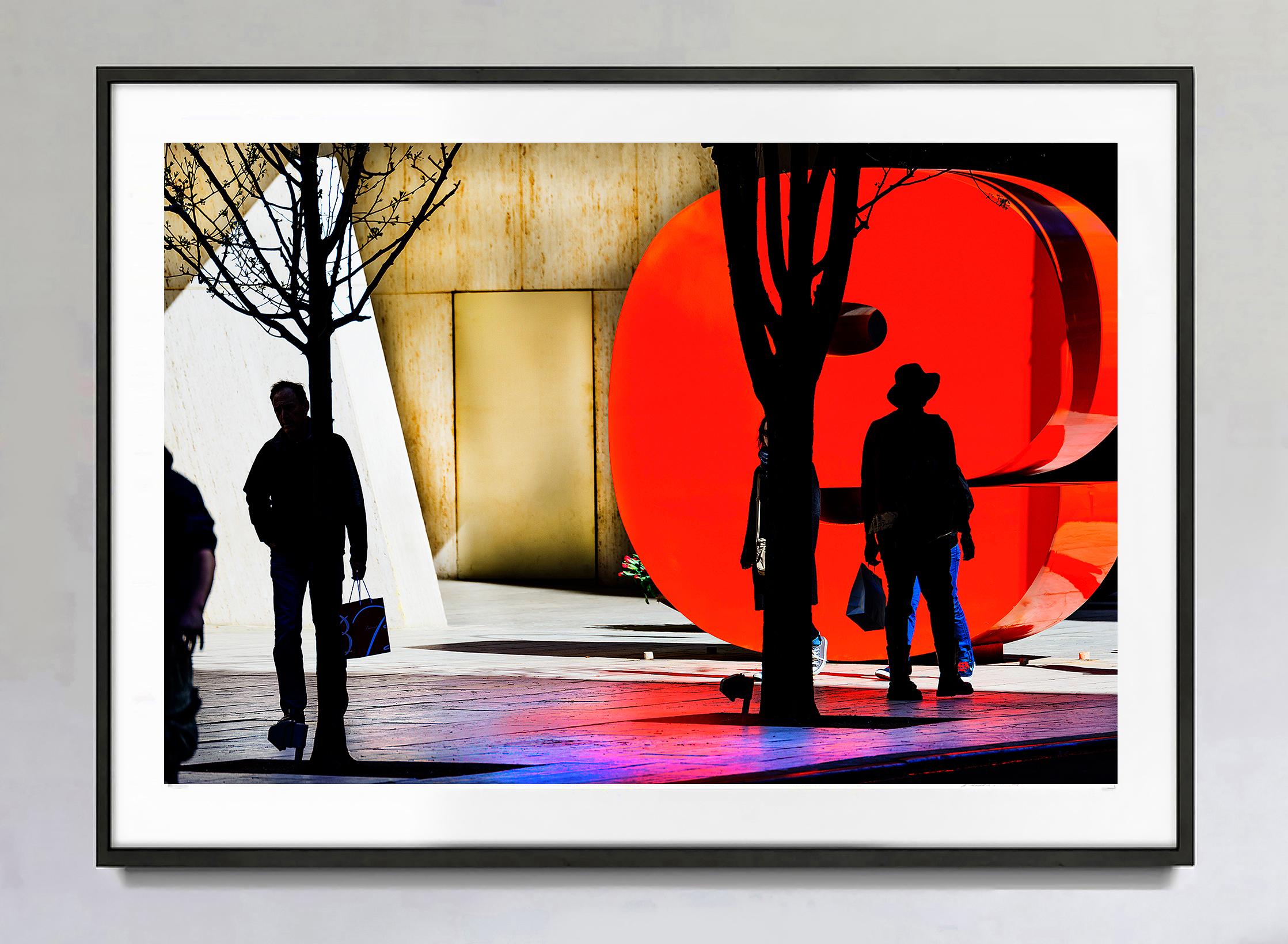 The Famous 9 West 57th Street red sculpture anchors a New York City street photograph that is part representation and part abstract. 
Signed dated and numbered 3/15 lower right recto, other sizes available, printed later, unframed. This work is