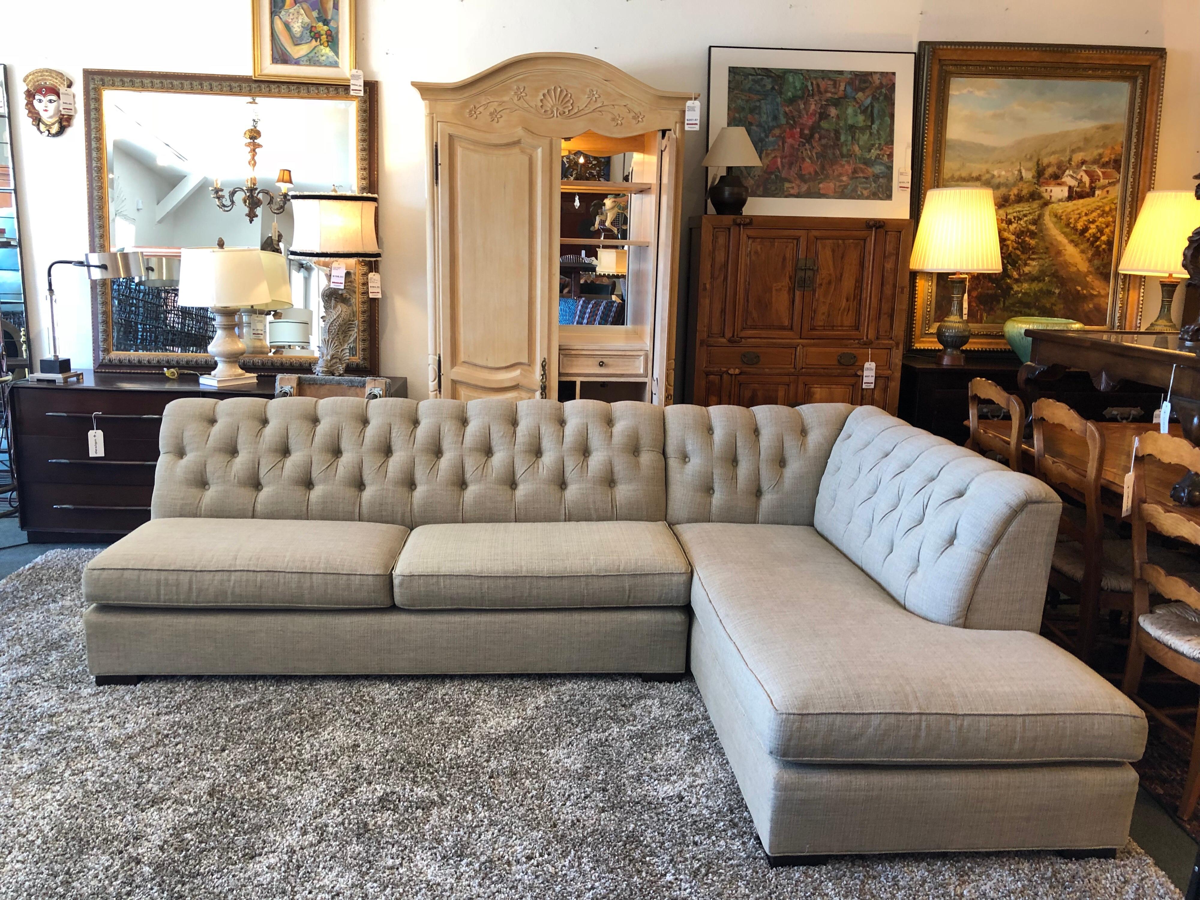 A two-piece sectional by Mitchell-Gold. The tufted seating is the perfect balance between traditional and contemporary, offering both clean lines and deep tufting. Fabric has a multi-color woven weave that reads grey with a hint of